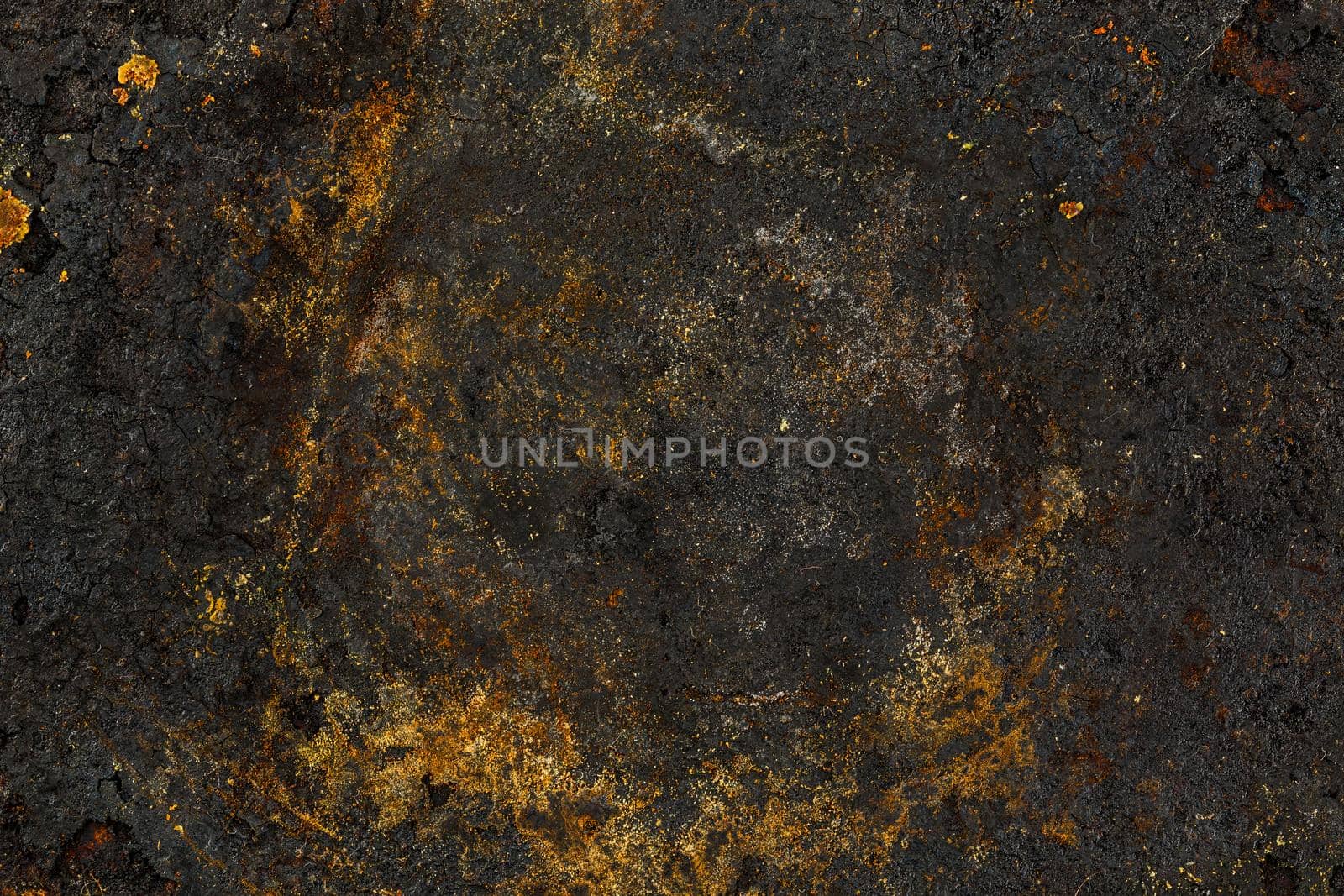 Bottom side of a cast iron pan with thicl layer of soot on its surface. Texture and background.