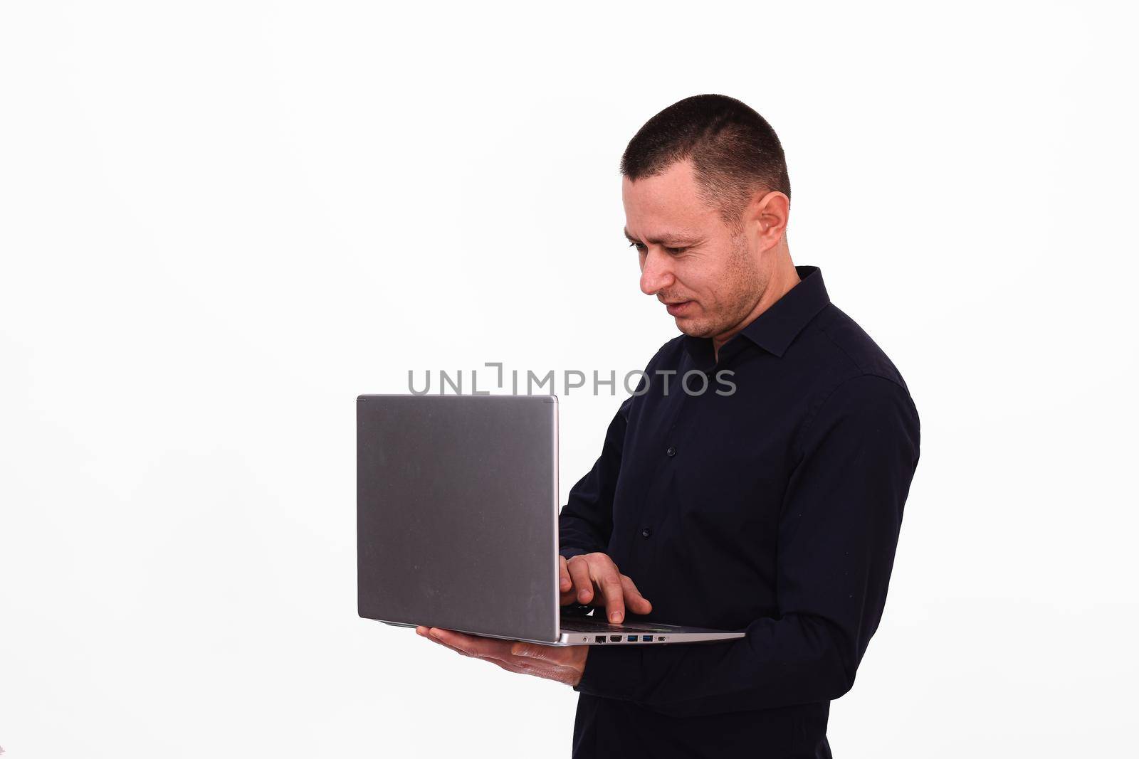 A man with a laptop is working. Isolated on a white background. copy space