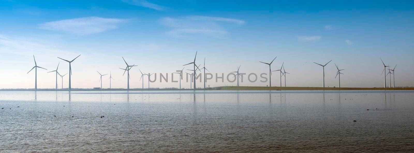 wind turbines under blue sky on philipsdam in dutch province of Zeeland in the netherlands in the netherlands