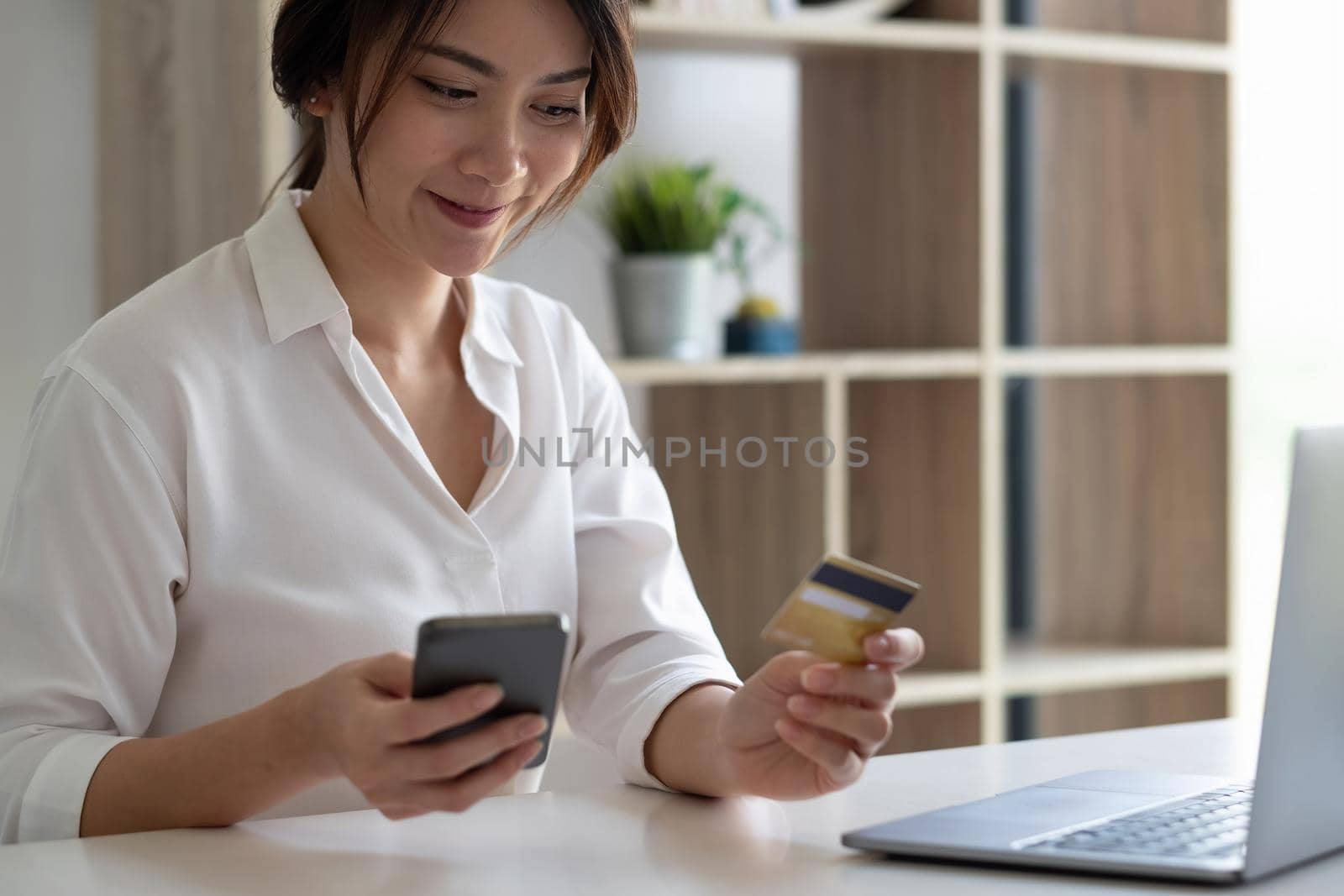 Holiday shopping online. Young woman makes purchases in the Internet using smartphone on Black Friday.