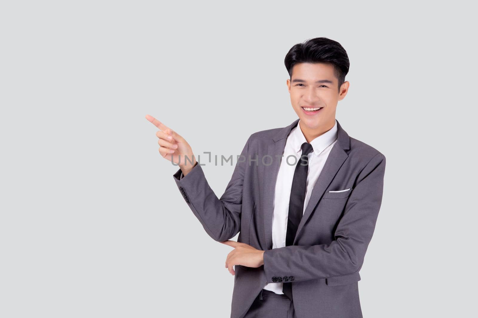 Portrait young asian business man pointing and presenting isolated on white background, advertising and marketing, executive and manager, male confident showing success, expression and emotion.