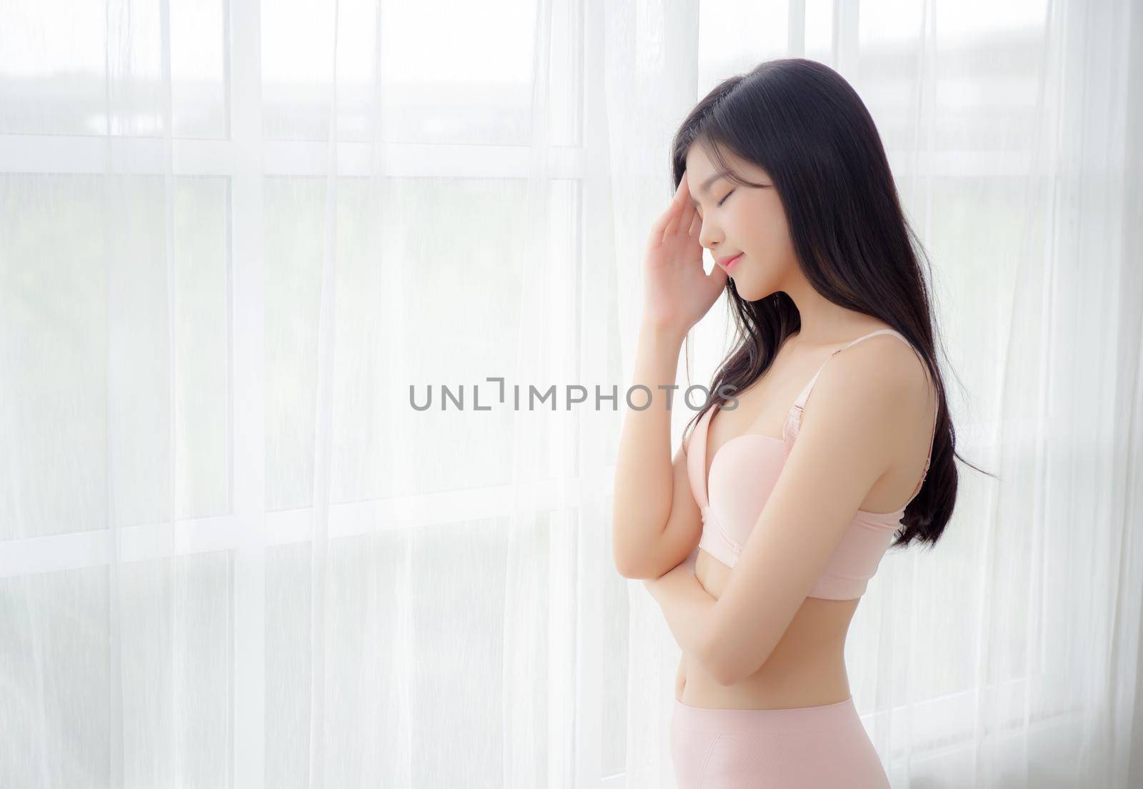 Beautiful portrait young asian woman sexy thinking idea weight loss near the windows for healthy, body of asia girl happy with diet and cheerful with wellbeing, lifestyle and relax concept.