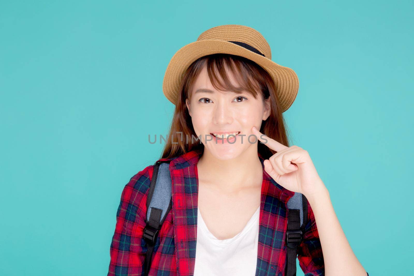 Beautiful portrait young asian woman smile expression cheerful and enjoy travel summer trip holiday in vacation isolated blue background, tourist happy asia girl confident and excited.