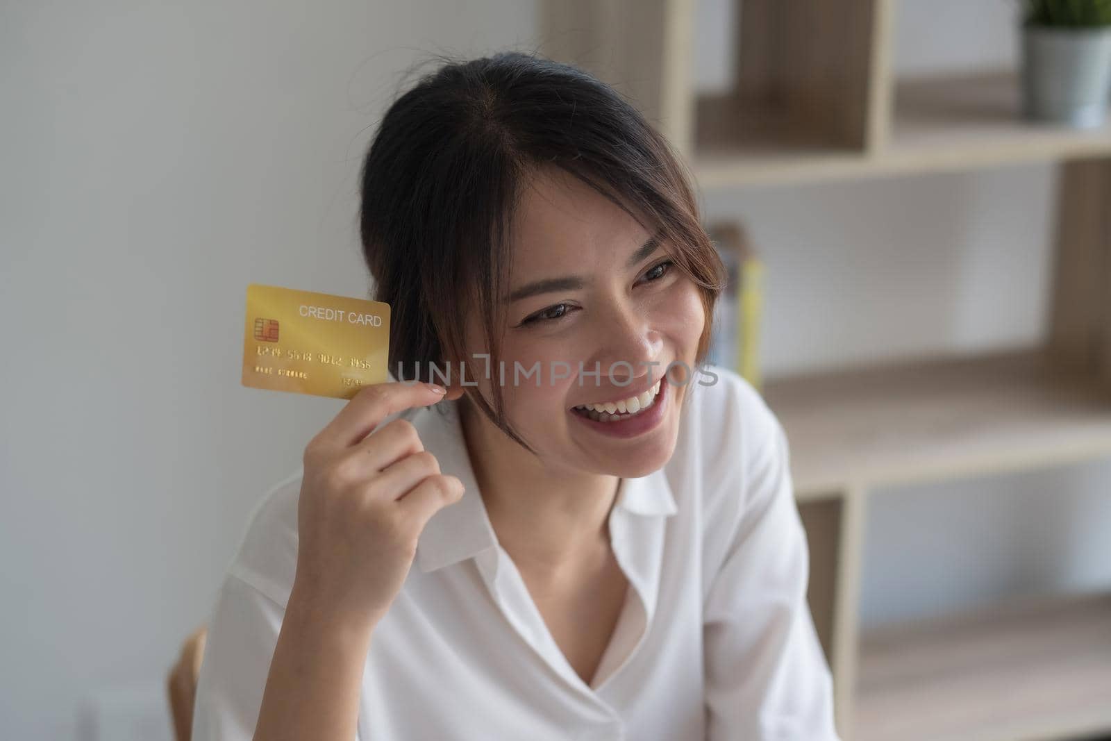 Portrait of beautiful asian woman holds credit card. Smiling and happy for shopping online.