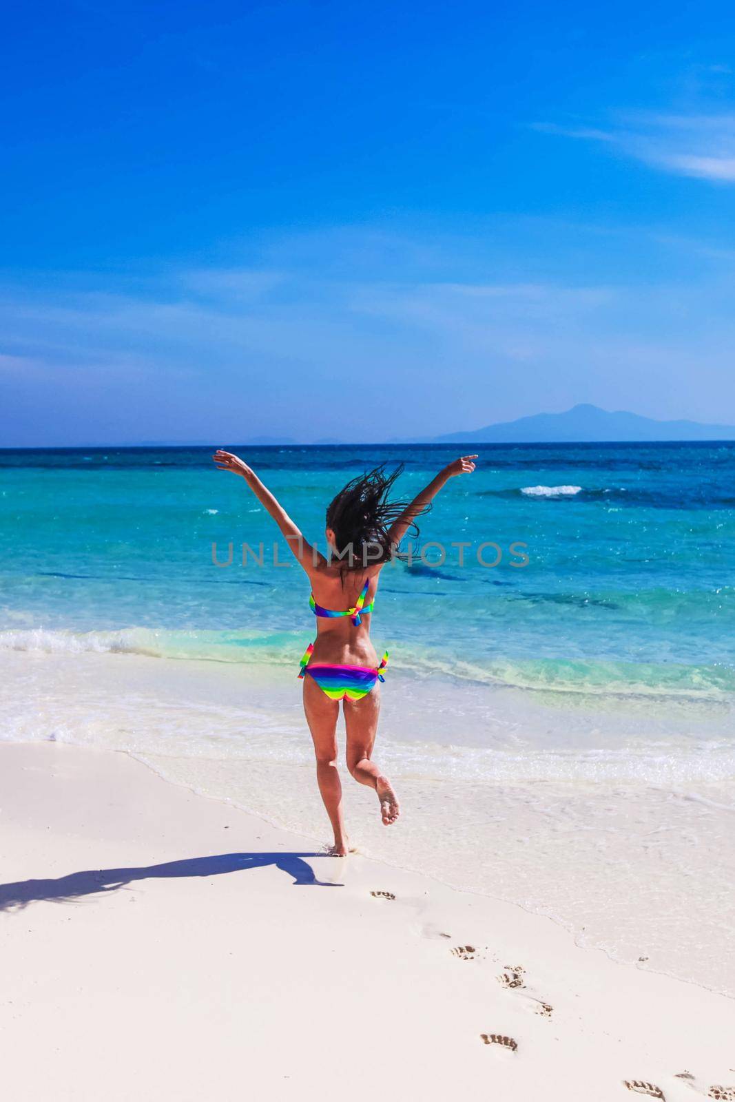Happy girl running to tropical sea by Yellowj