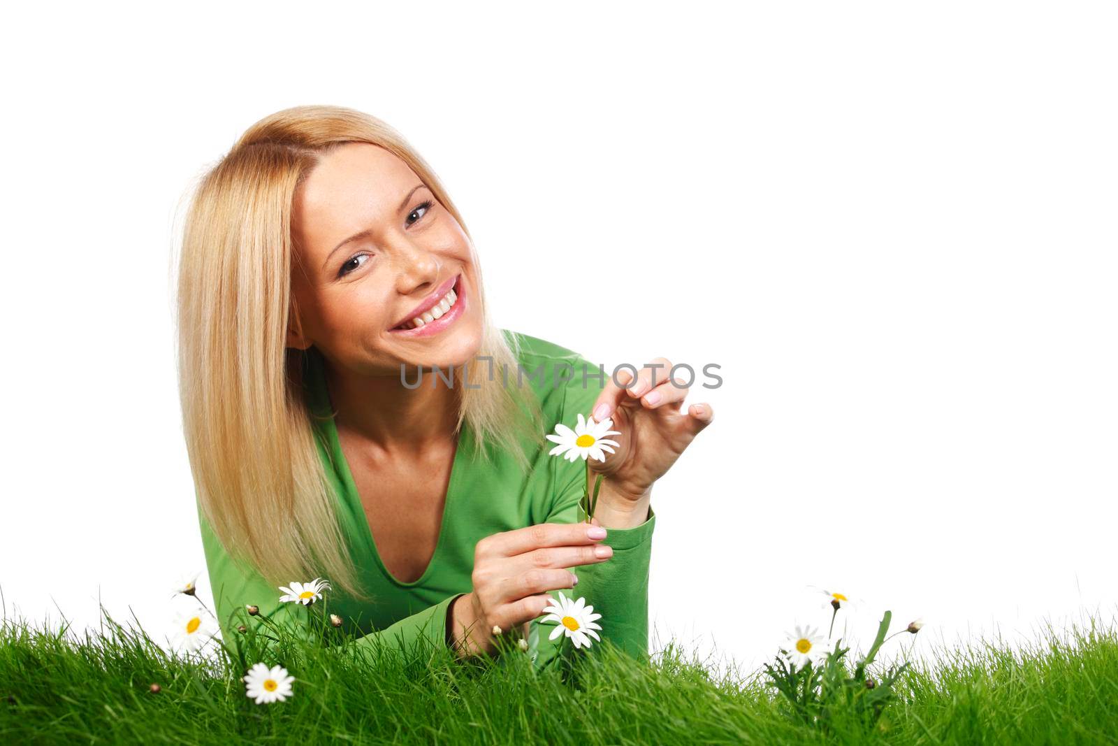 Happy young woman lying on grass with chamomile flowers, isolated on white background