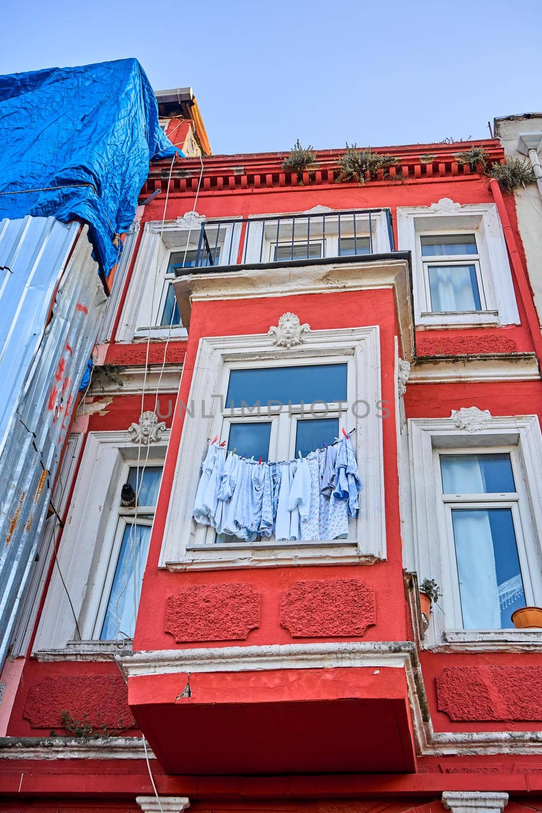 Usual life. The multicolored clothes dry on the rope. A picturesque old district in Istanbul. Low rise colorful houses and narrow cozy streets.