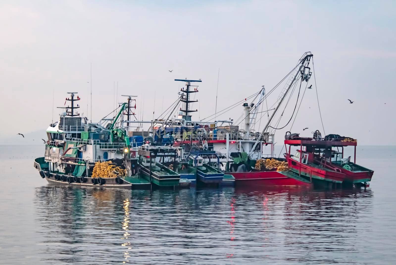 fishing season and fishing boats at marmara sea in kumkapi district. by yilmazsavaskandag