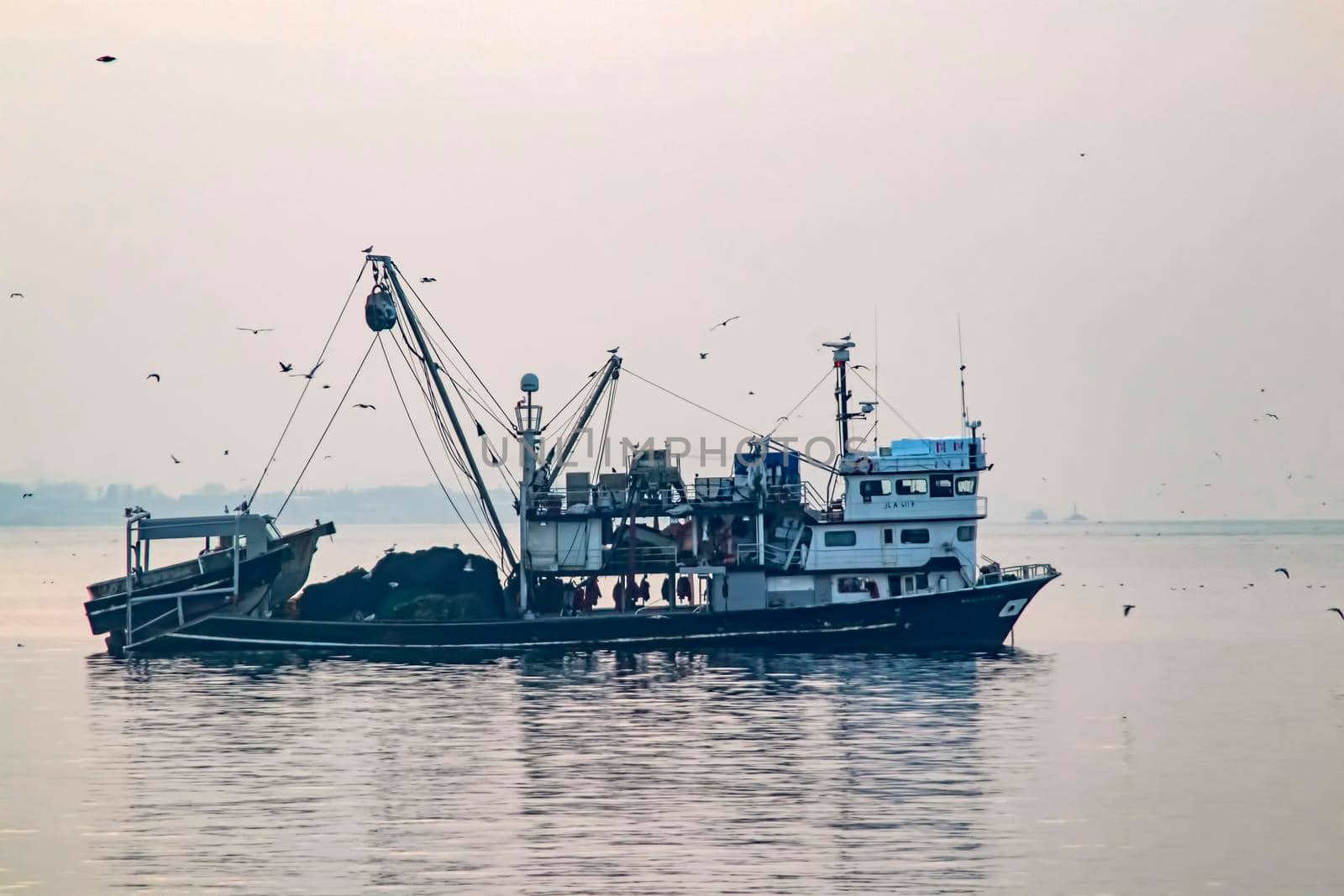 fishing season and fishing boats at marmara sea in kumkapi district. by yilmazsavaskandag