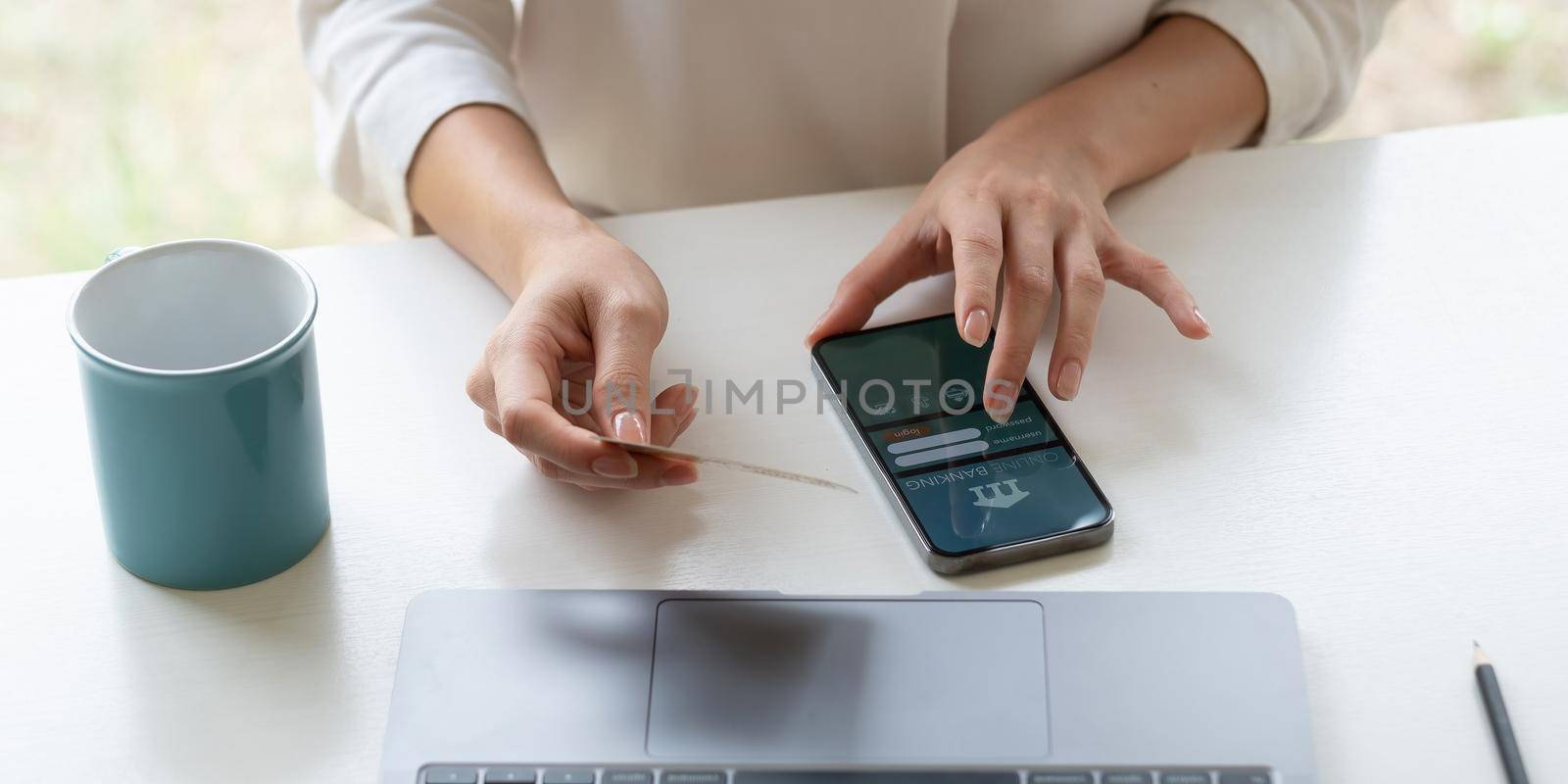 Close up of female hands making online payment for online shopping at home.