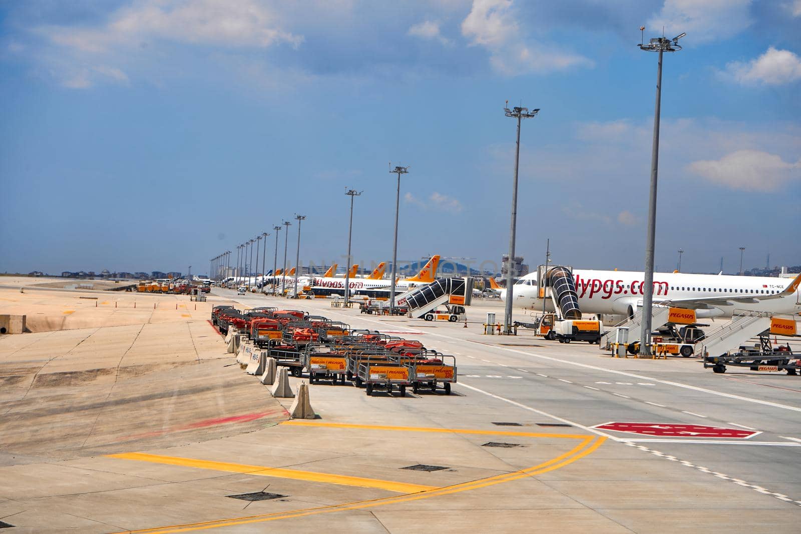 Carts for transportation and loading of passengers' belongings on the plane in the parking lot near the plane. Airport special transport. Turkey , Istanbul - 21.07.2020