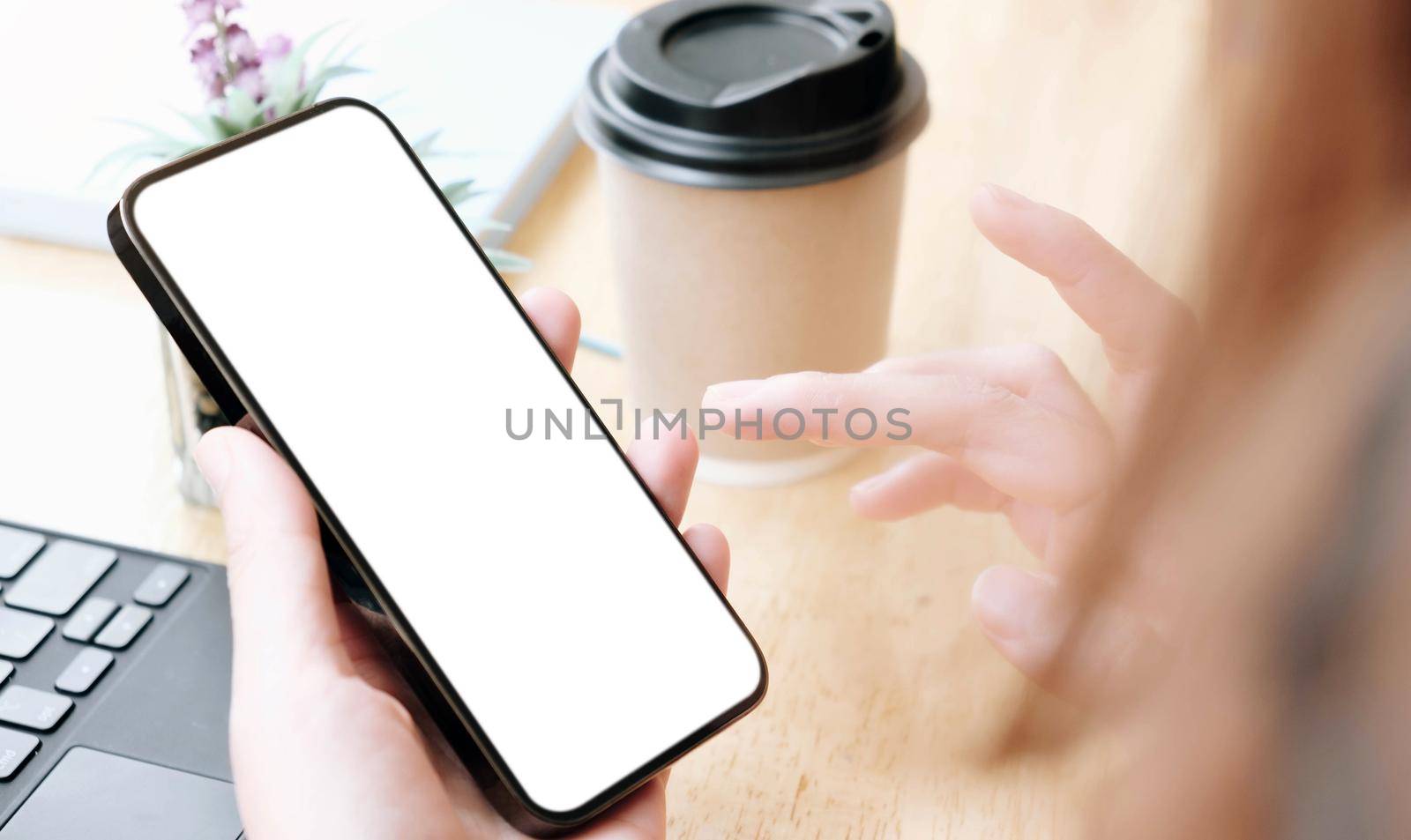 Top view Woman sitting and holding blank screen mock up mobile phone
