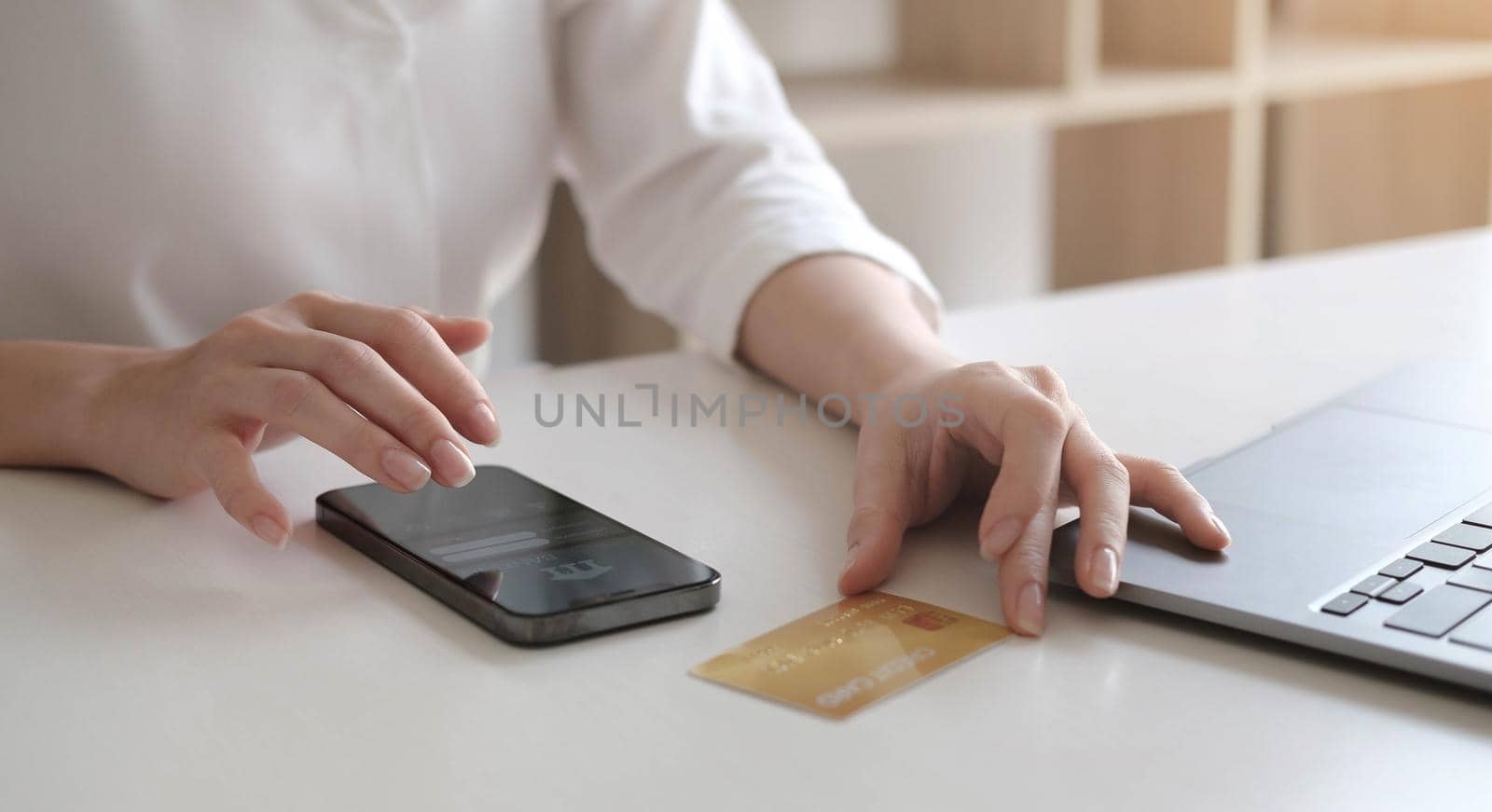 Online payment,Woman's hands holding smartphone and using credit card for online shopping.
