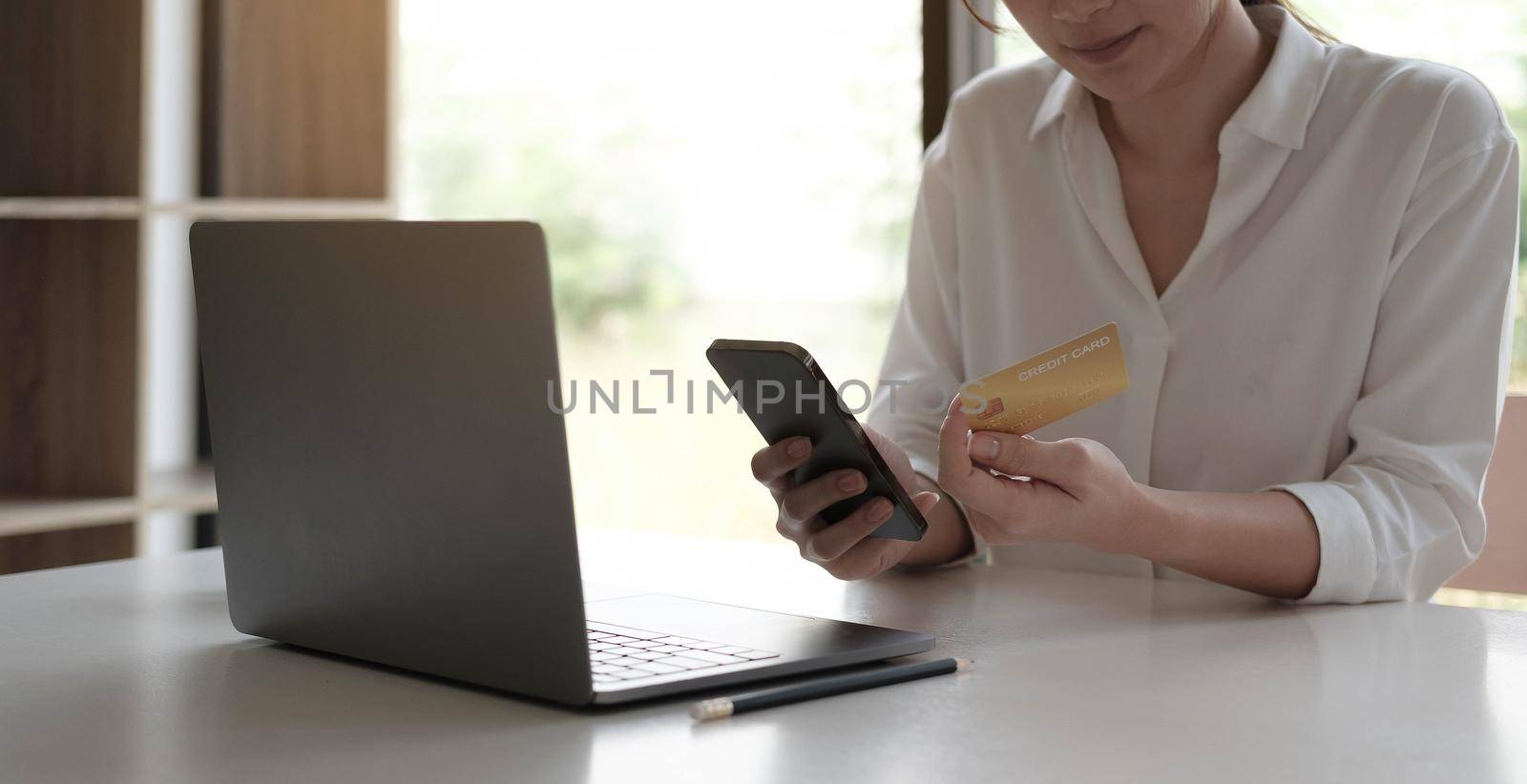 Upset young woman using online banking service, problem with blocked credit card, using laptop, irritated girl checking balance, internet fraud concept, bankruptcy or debt, overspend by wichayada