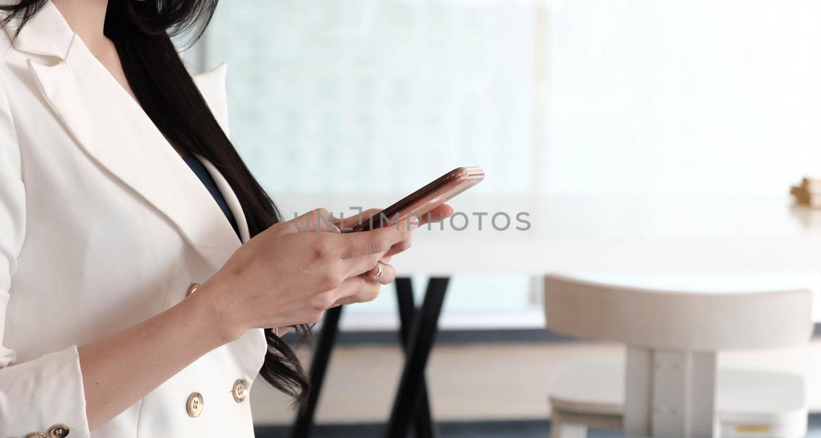  woman user holding smart phone watching video, playing game, shopping, chatting in mobile technology application.

