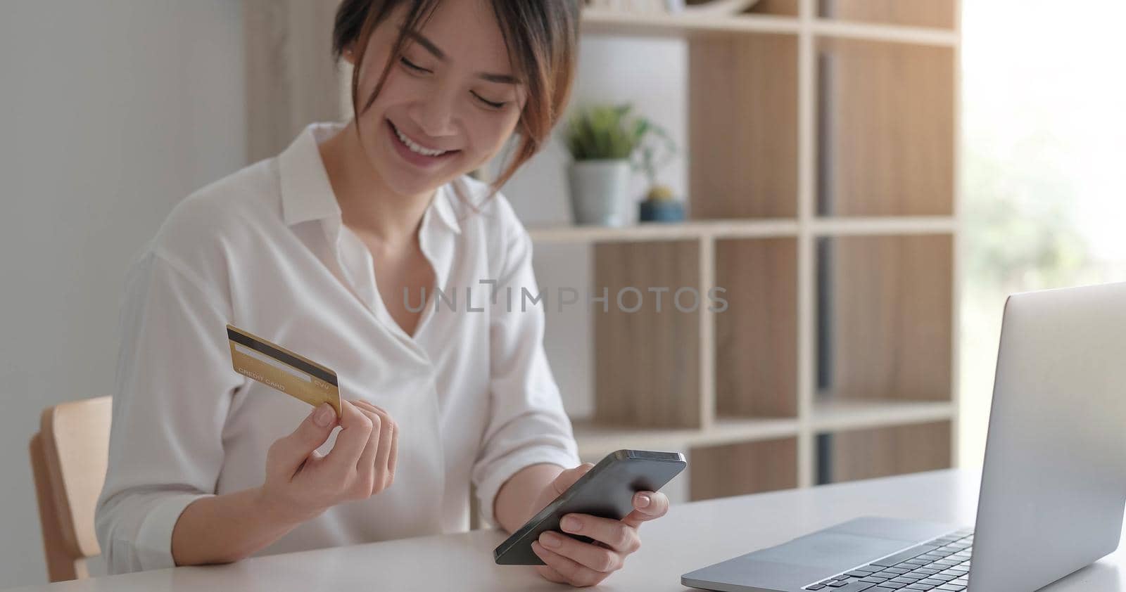 Mobile banking, Online shopping, digital banking, internet payment concept. Woman hand using mobile smart phone payments and credit card for online shopping by wichayada