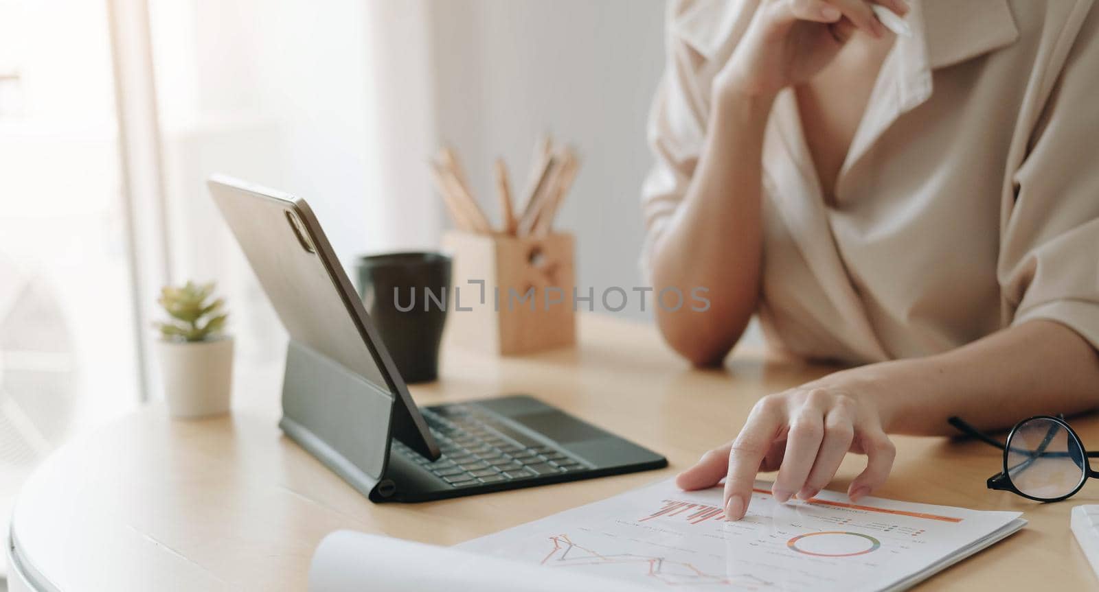 Businesswoman investment consultant analyzing company annual financial report balance sheet statement working with calculator and financial documents. Concept picture of business, market, office, tax.
