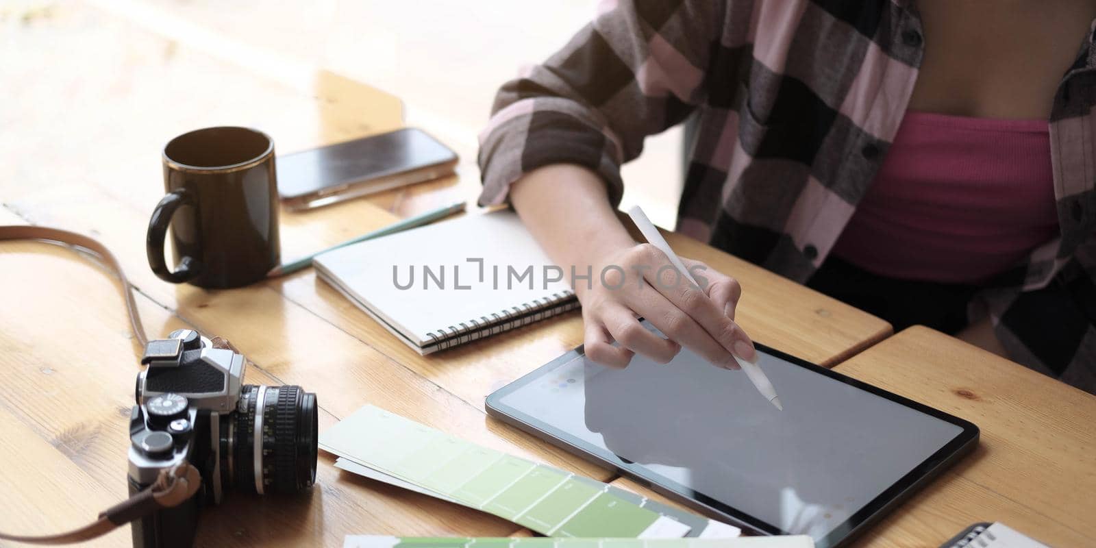 Close up of female hands and laptop with blank screen.