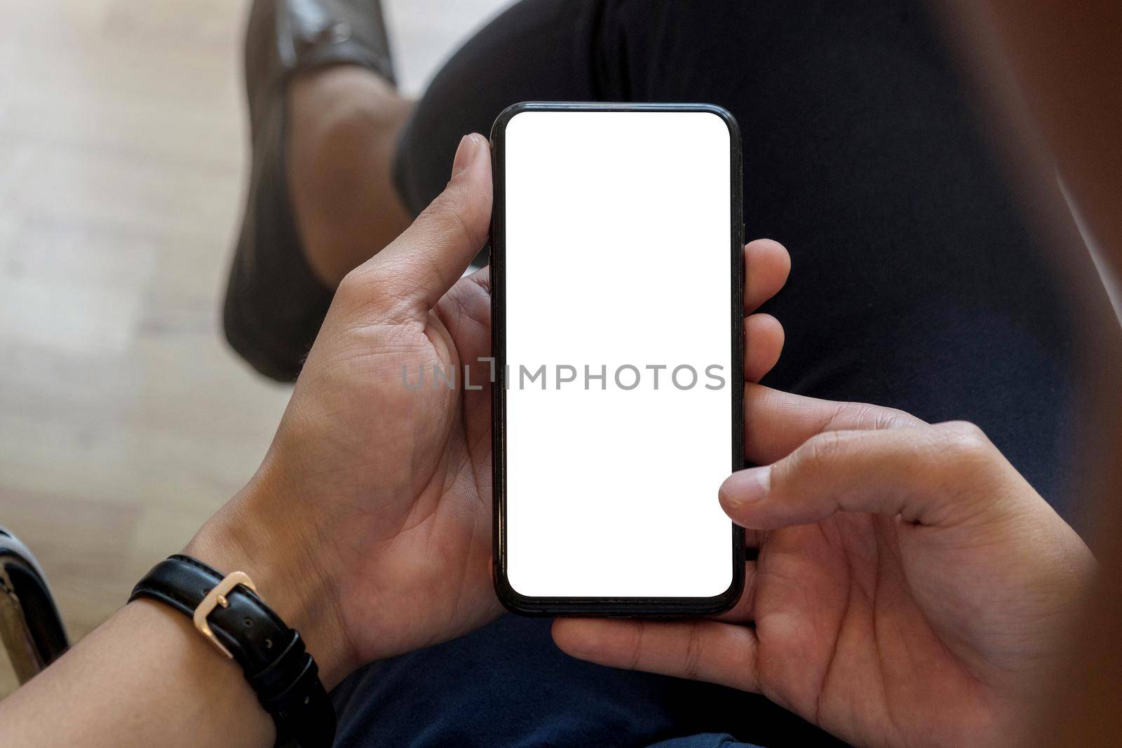 Man holding smart phone with blurred background. For Graphic display montage.
