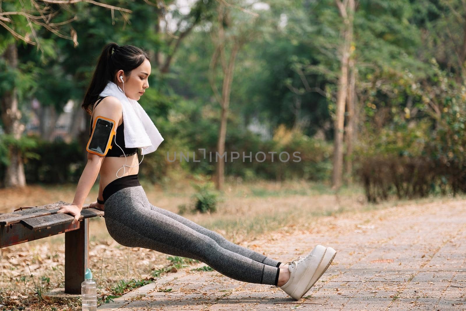 fitness, sport, exercising and lifestyle concept - woman stretching leg on stands