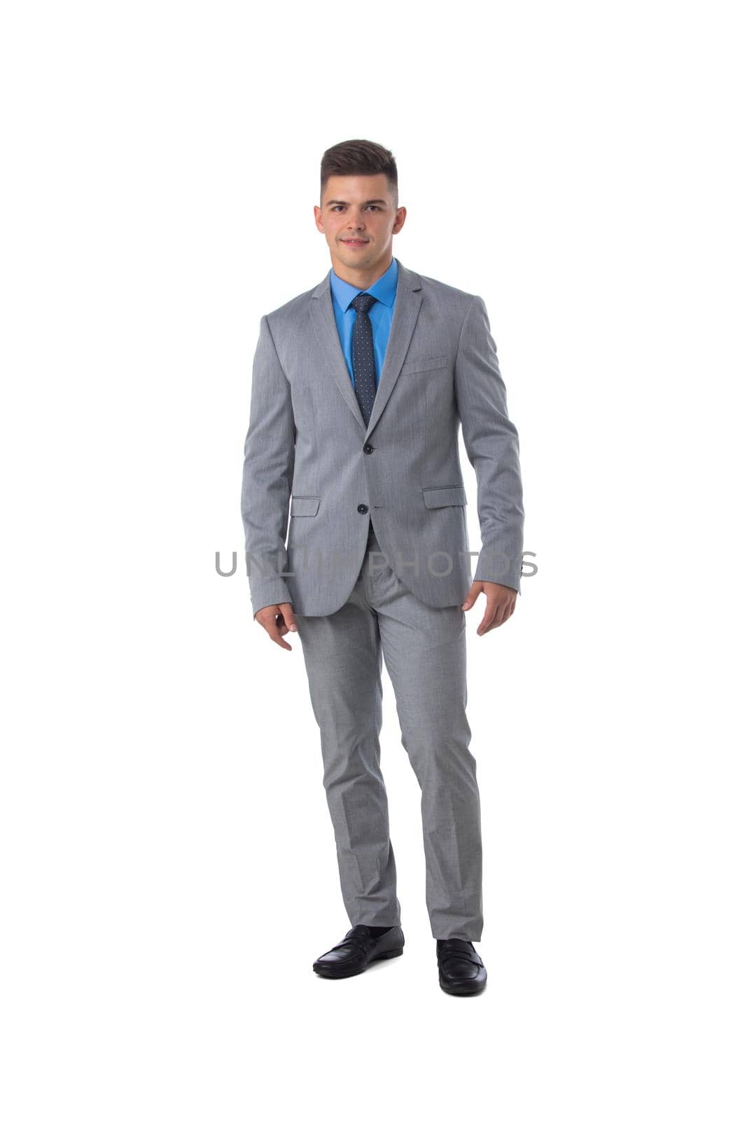Full length portrait of a young business man in gray suit isolated on white background