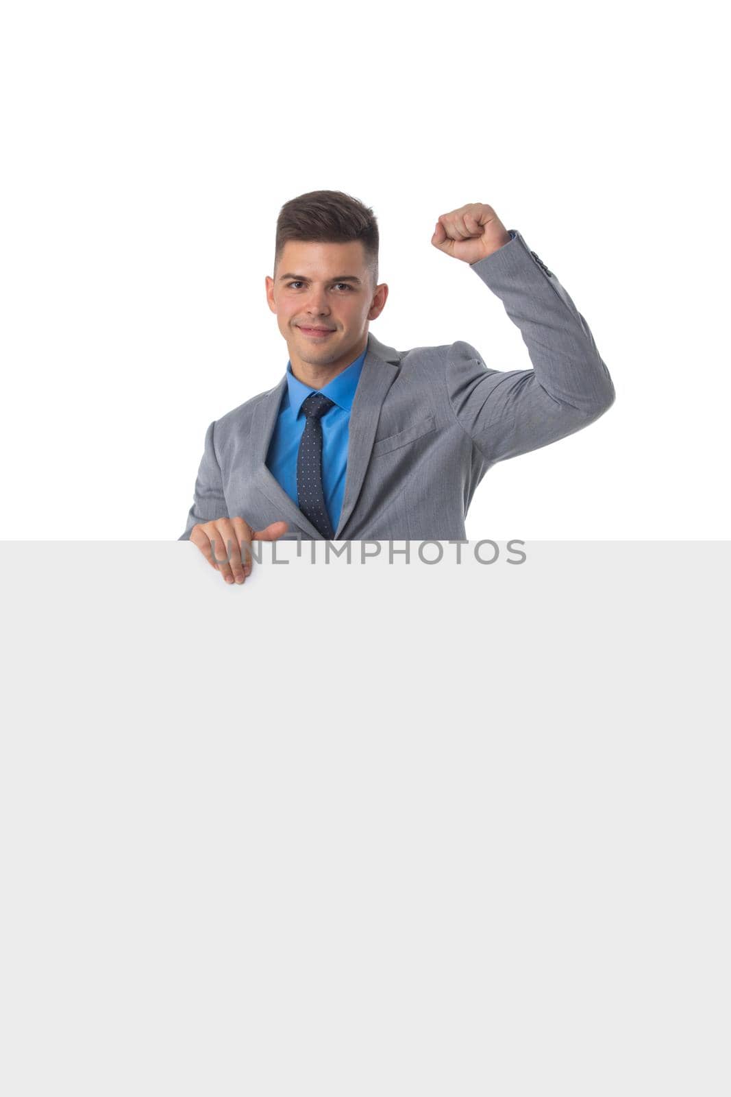 Young man in suit showing banner whiteboard sign isolated on white background