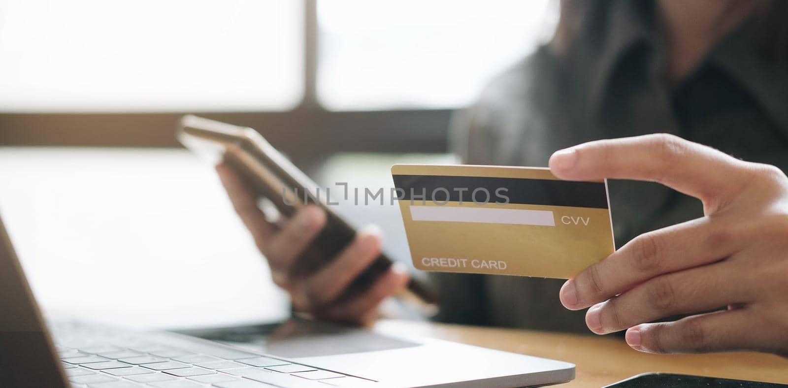 Hands holding credit card and using laptop. Online shopping	

