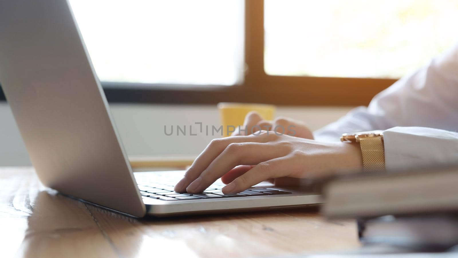 Close up of businesswoman or accountant hand holding pen working on laptop computer for calculate business data, accountancy document and calculator at office, business concept
