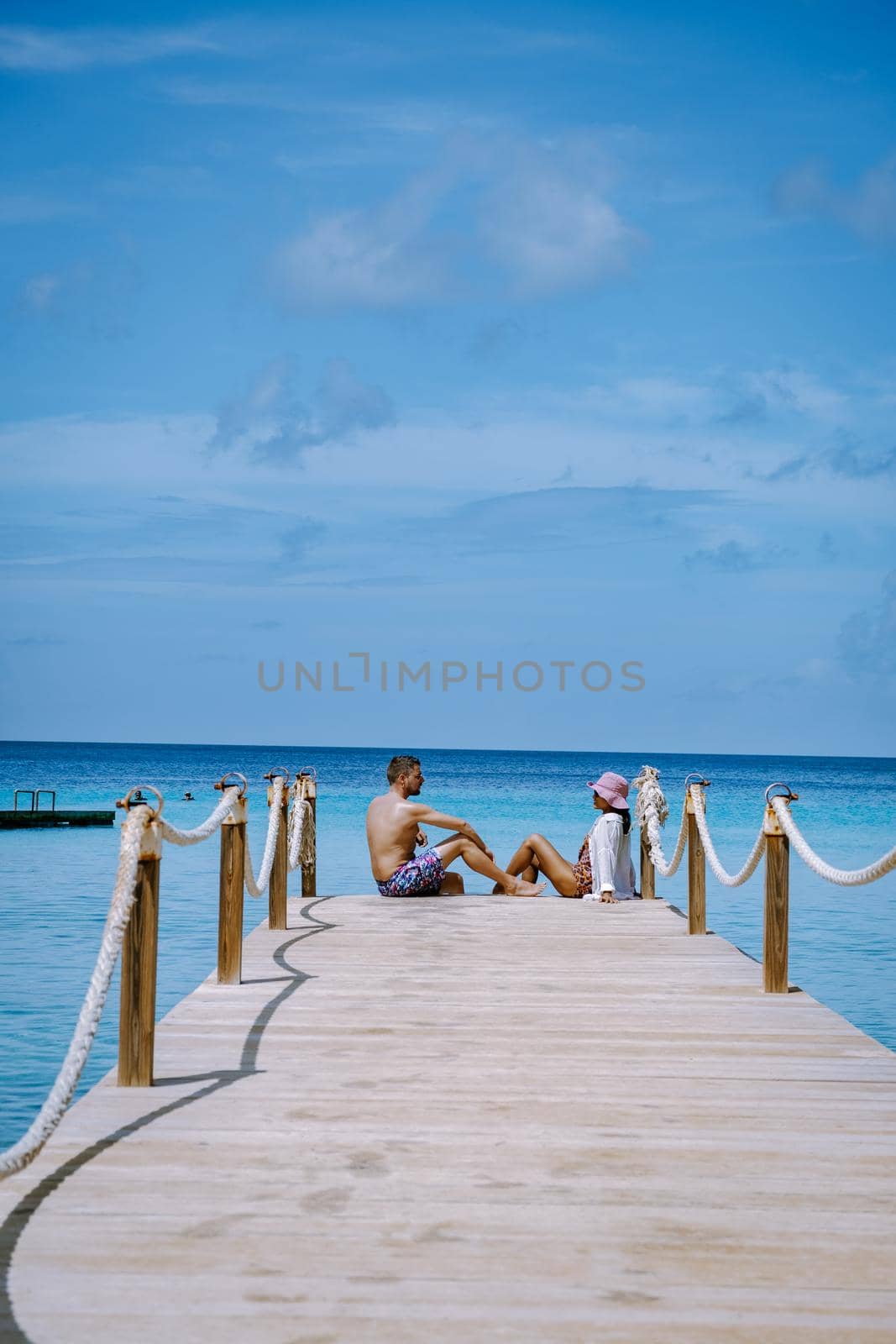 Curacao Caribbean Island, Kokomo Beach Views around the Caribbean island of Curacao on a bright day, couple mid age in swim short on the beach, men and woman on vacation at the beach