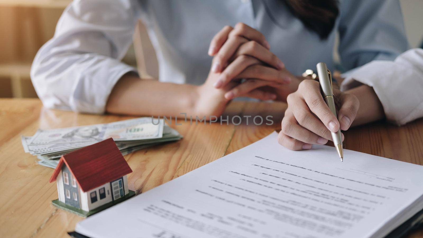 Real estate agent sign a contract documents agreement with customer to sign contract by wichayada