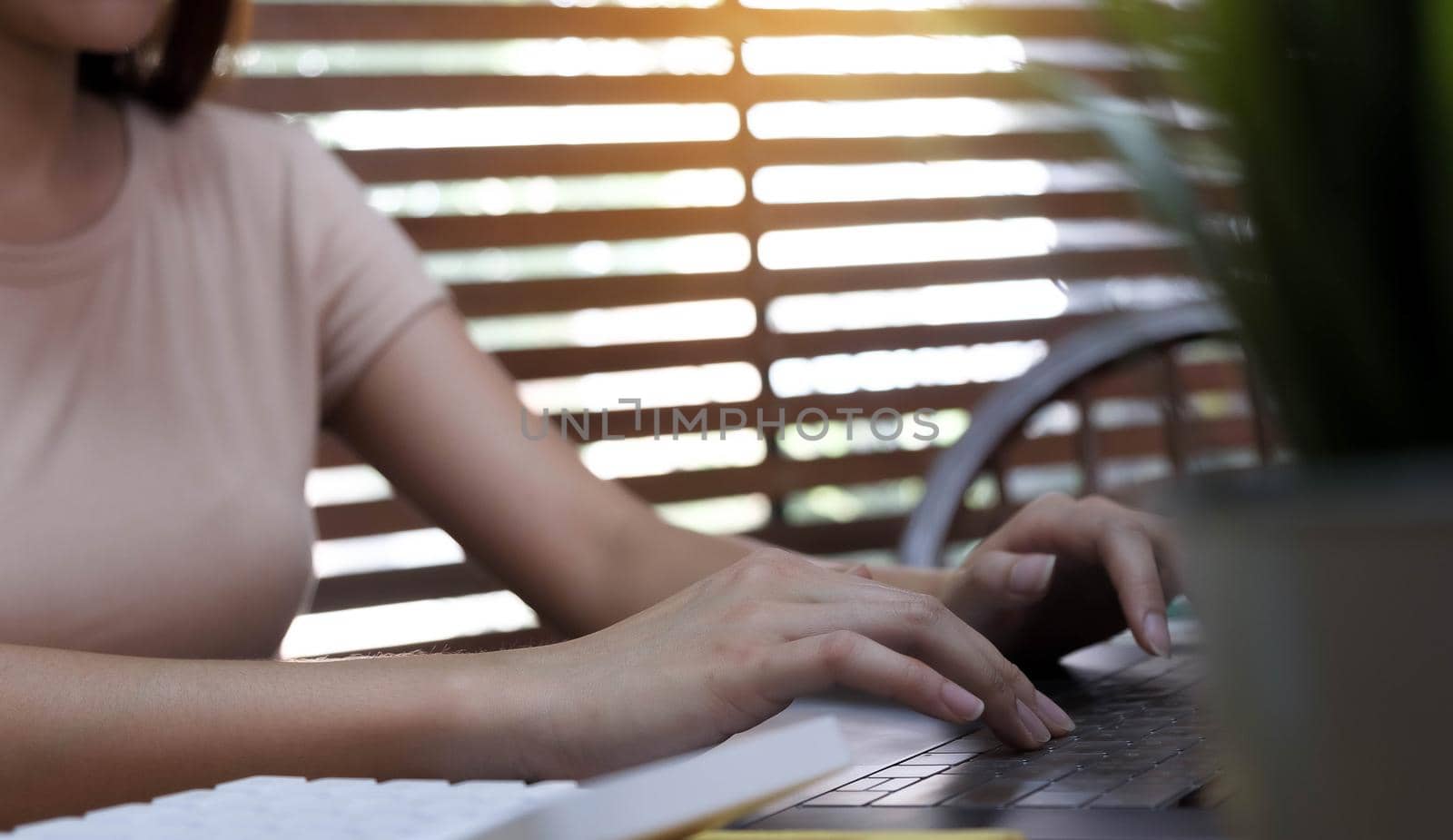 Close up of businessman or accountant hand holding pencil working on calculator to calculate financial data report, accountancy document and laptop computer at office, business concept
