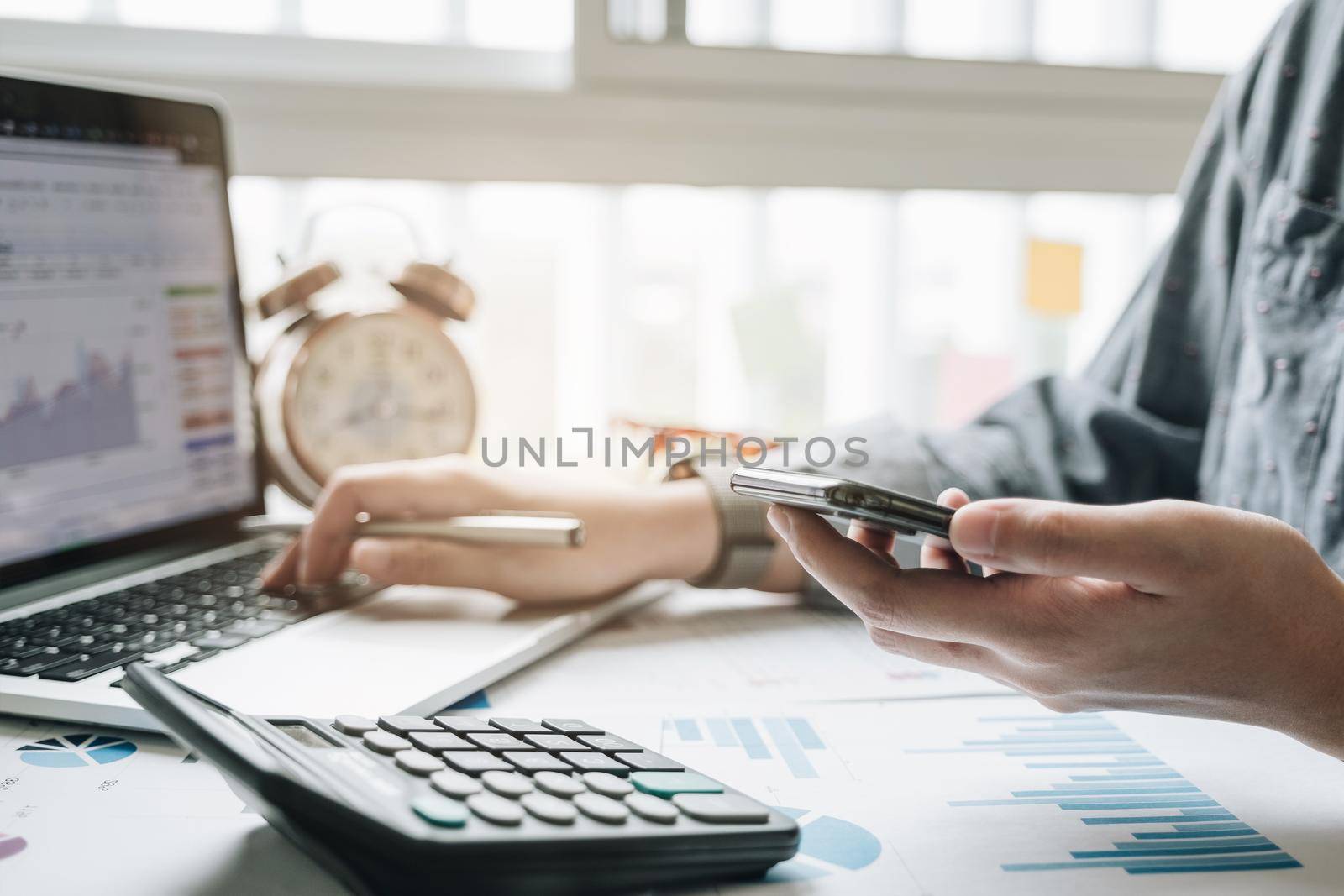 Close up view of bookkeeper or financial inspector hands making report, calculating or checking balance. Home finances, investment, economy, saving money or insurance concept by wichayada