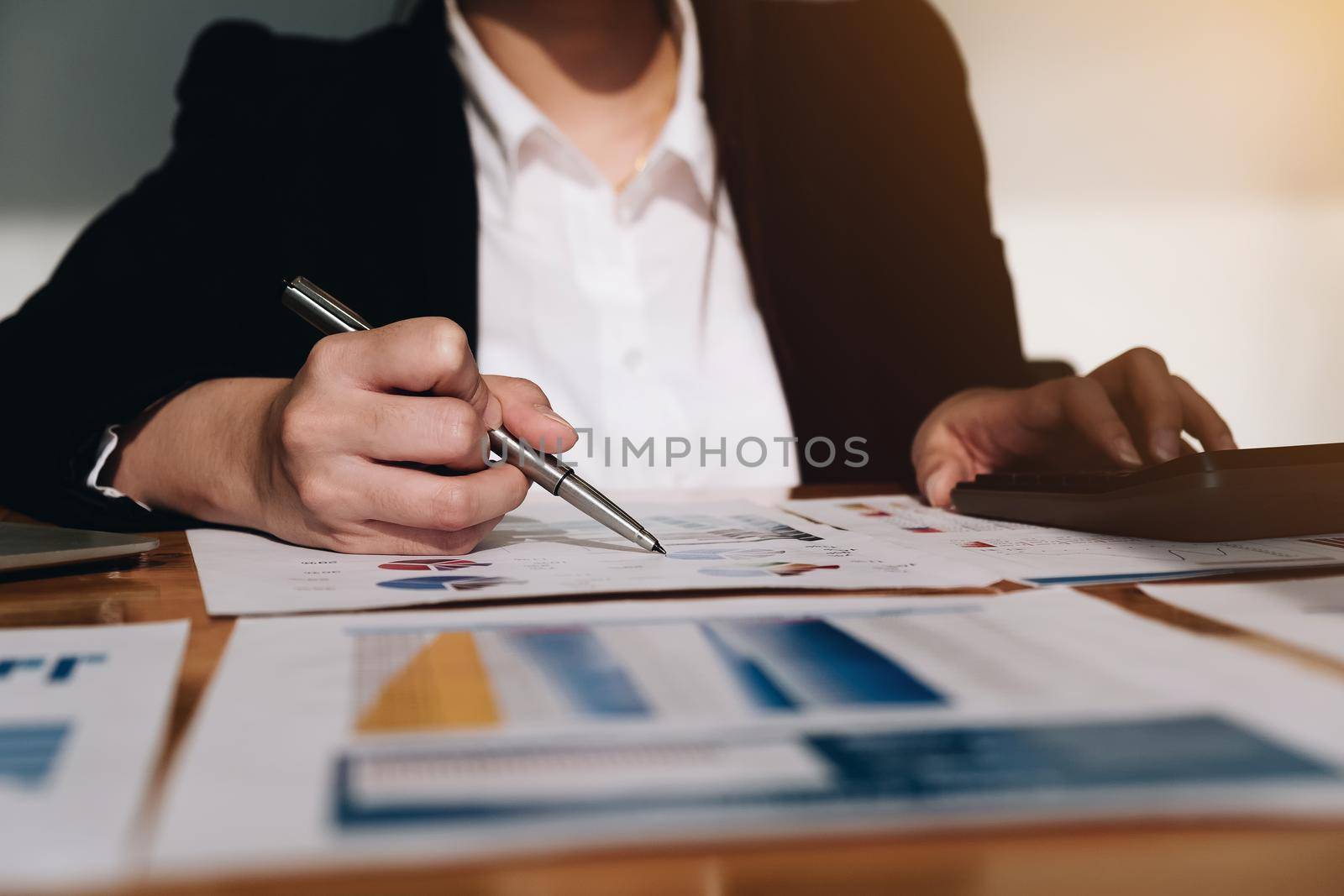 Business woman investment consultant analyzing company annual financial report balance sheet statement working with documents graphs. Concept picture of business, market, office, tax.

