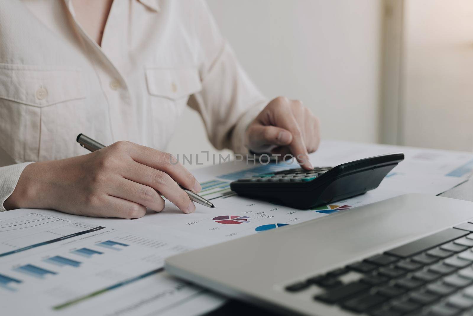 Business woman working in finance and accounting Analyze financial budget in the office
