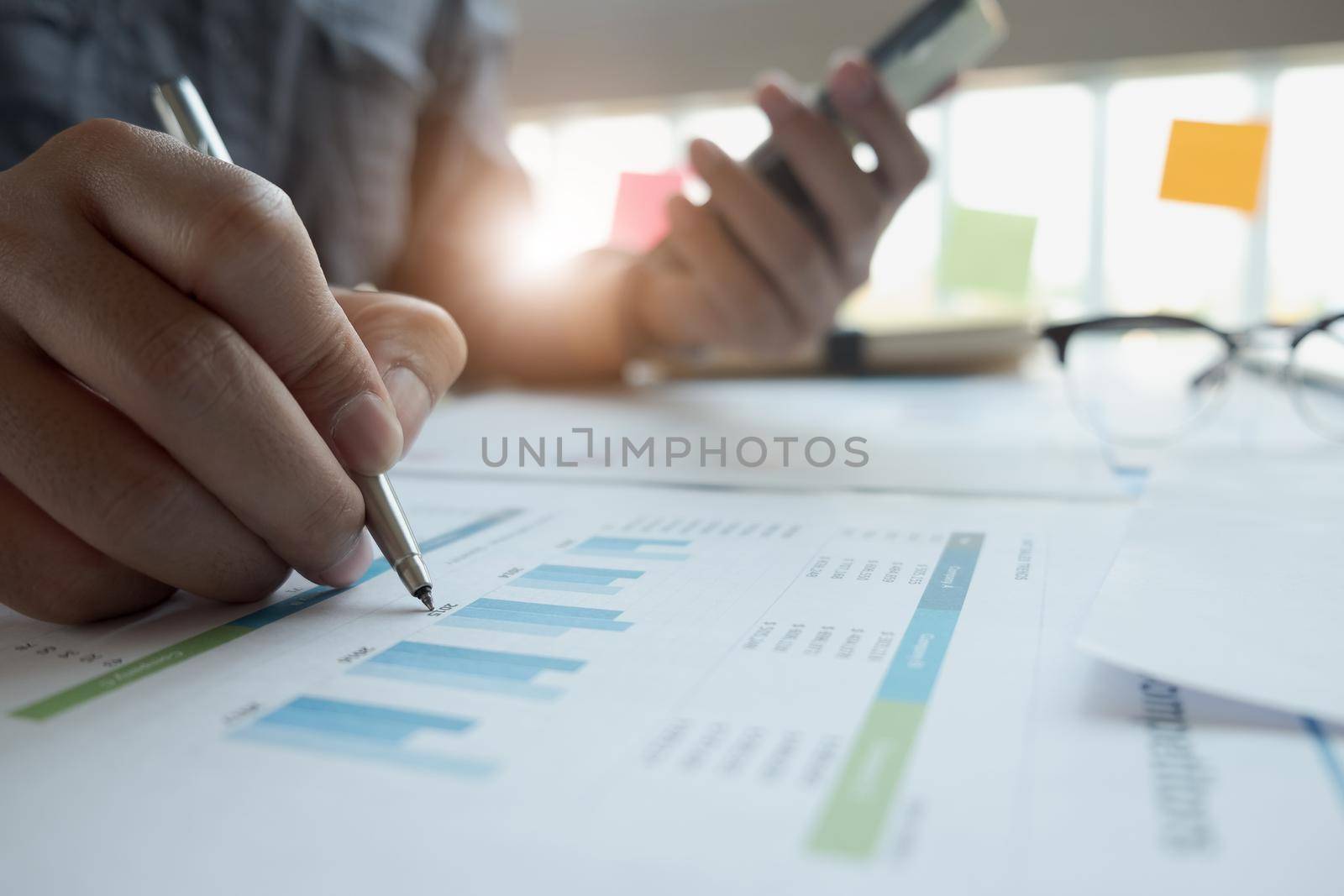 Business man investment consultant analyzing company annual financial report balance sheet statement working with documents graphs. Concept picture of business, market, office, tax.
