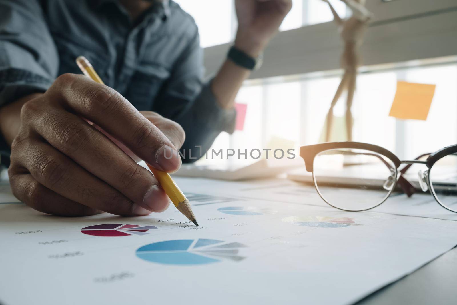 Photo of hands holding pencil and pressing laptop computer for calculating financial marketing
