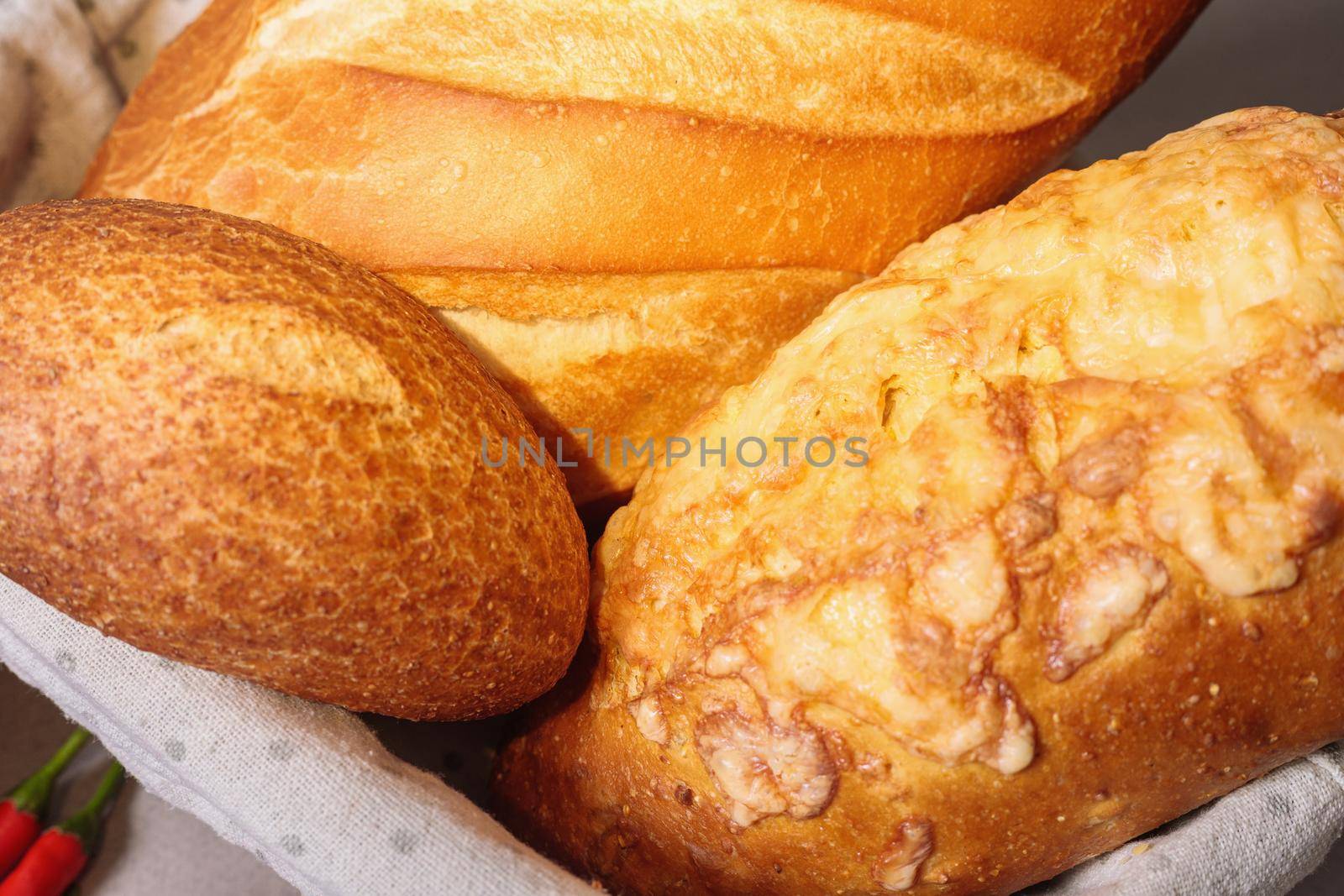 Fresh bread in a basket on a table with a fried crust. Close-up