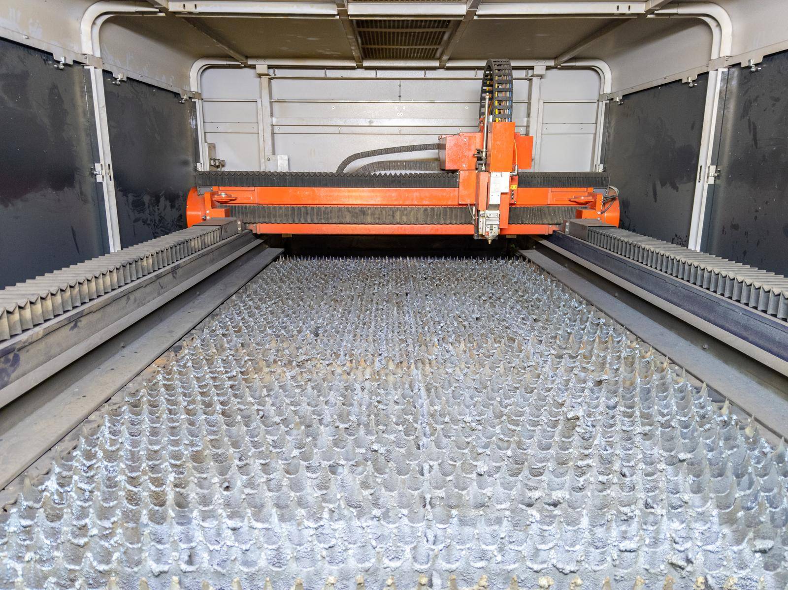 inside of empty cnc laser cutting machine - without workpiece metal sheet, only bare supporting bed slats table