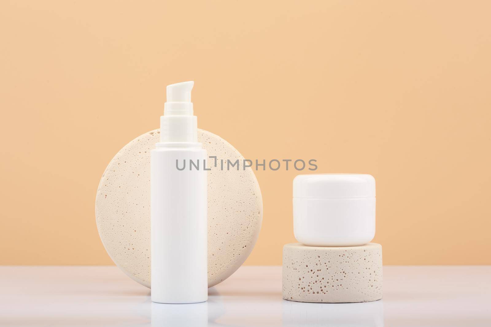 Face cream and mask with stone podiums against beige background. Concept of natural cosmetics by Senorina_Irina