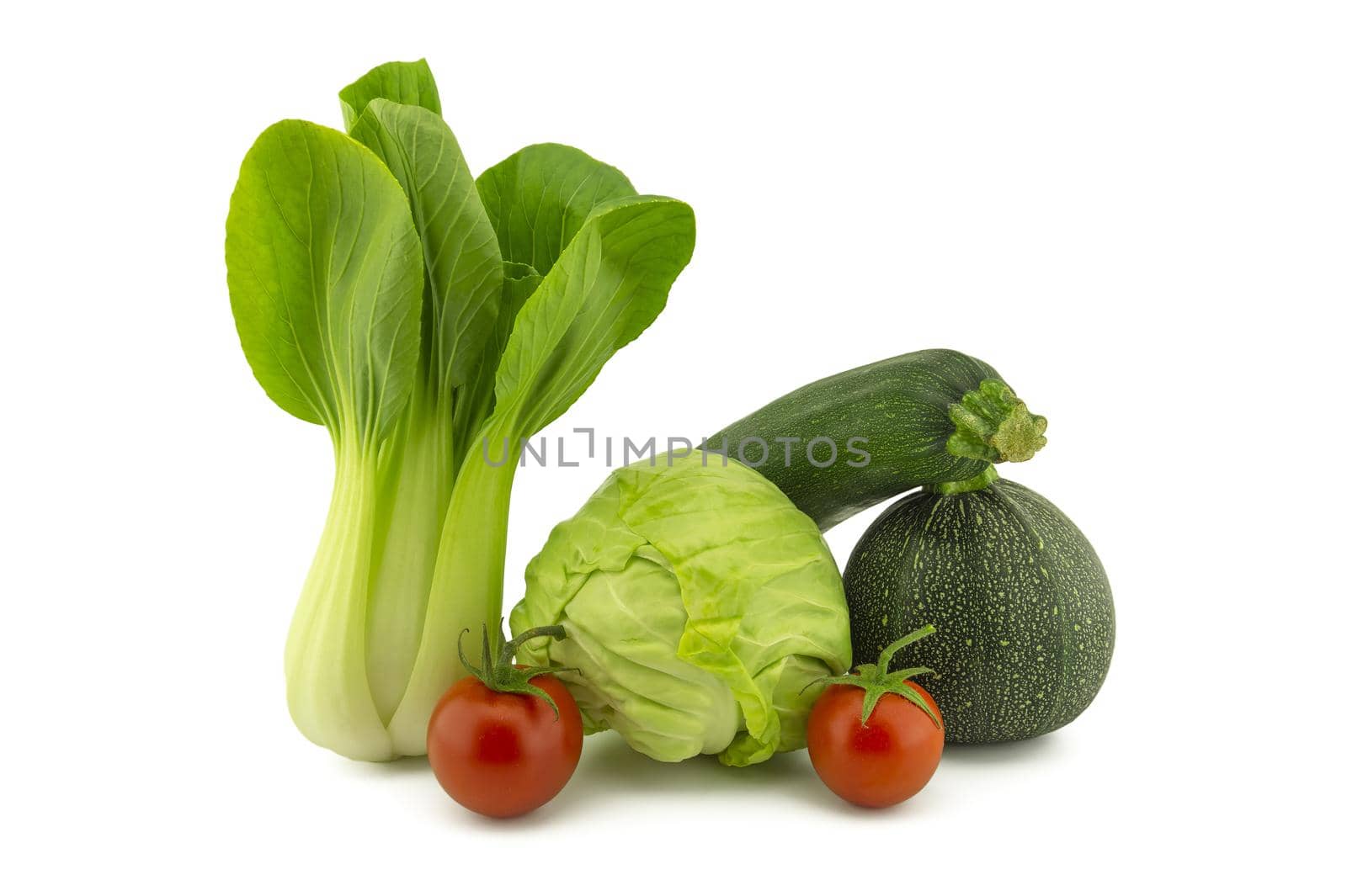 Chinese cabbage and white cabbage green round courgette, zucchini and cherry tomato isolated on white background