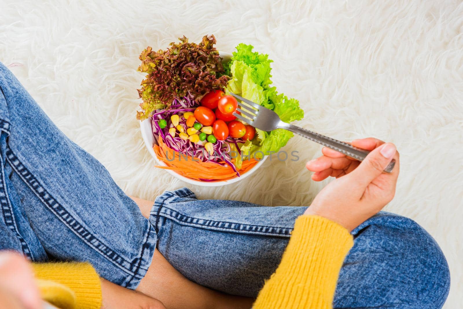 Female hands holding bowl with green lettuce salad by Sorapop