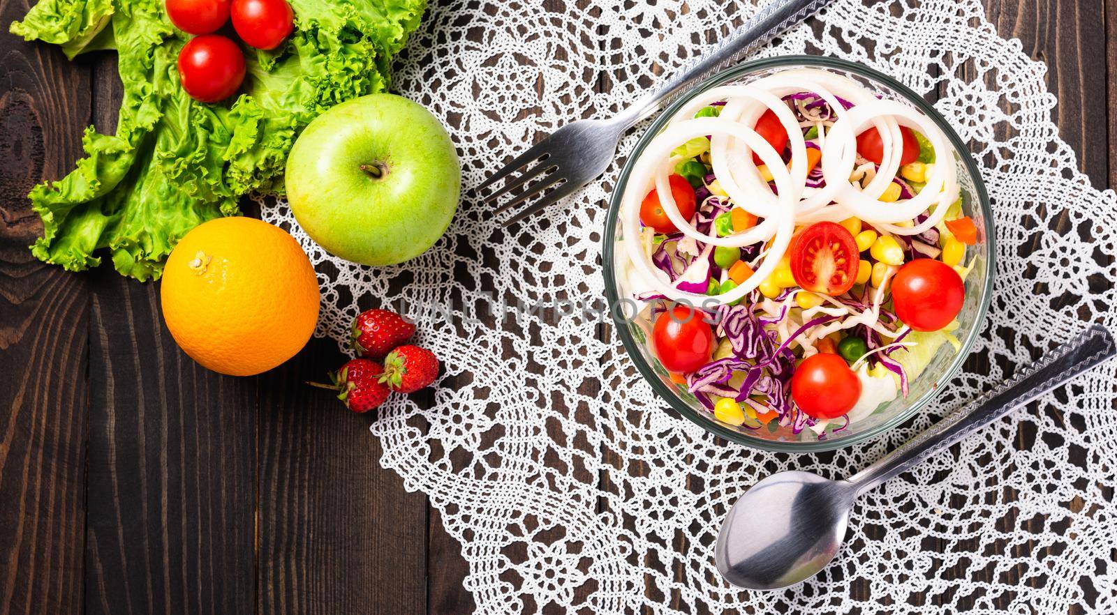 Top view of the healthy colorful fresh salad bowl with quinoa, tomatoes, and mixed greens vegetable in a dish on black wooden background, Health snack food