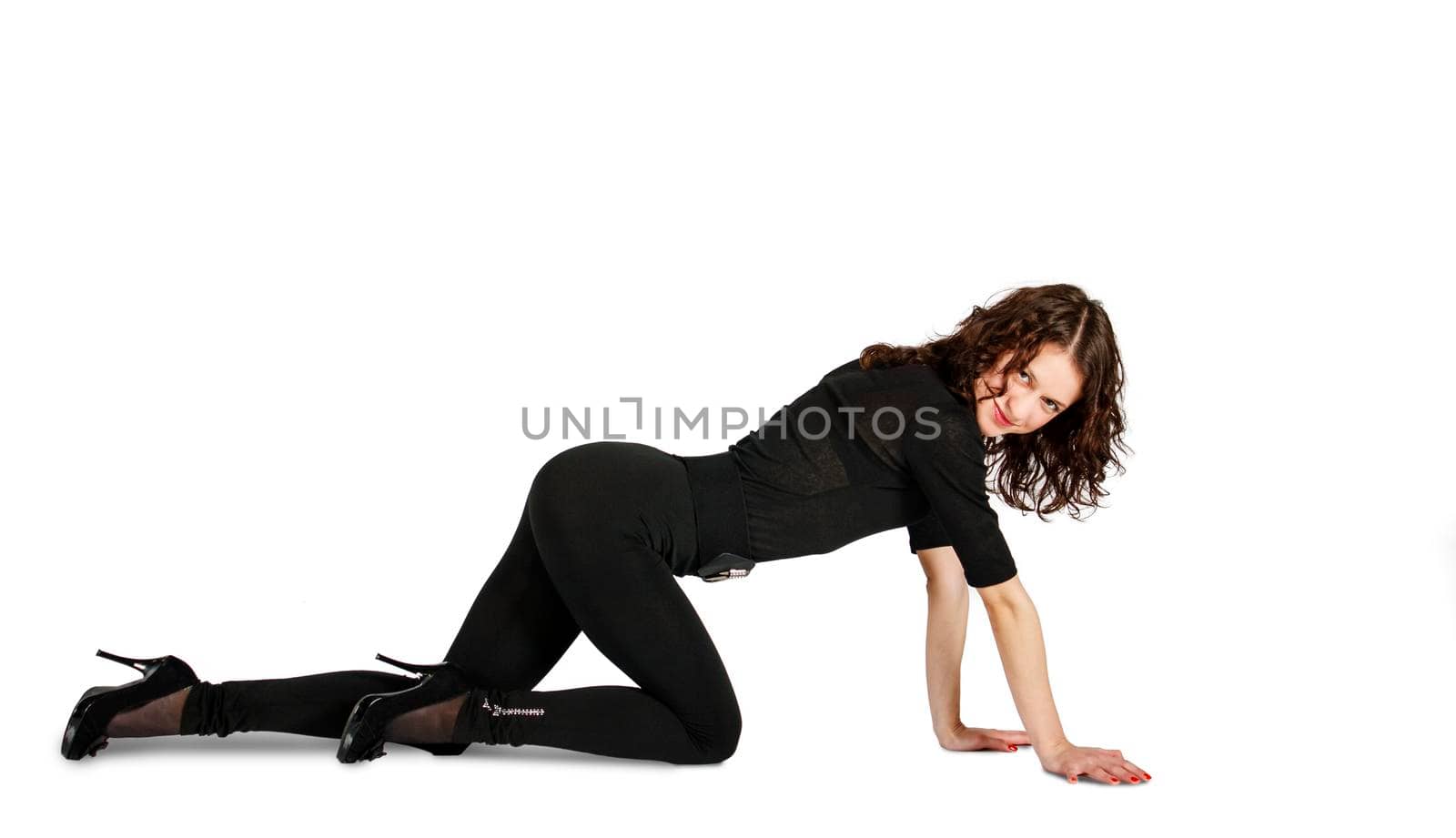 young beautiful woman in black suit posing standing on all fours in the studio on white background