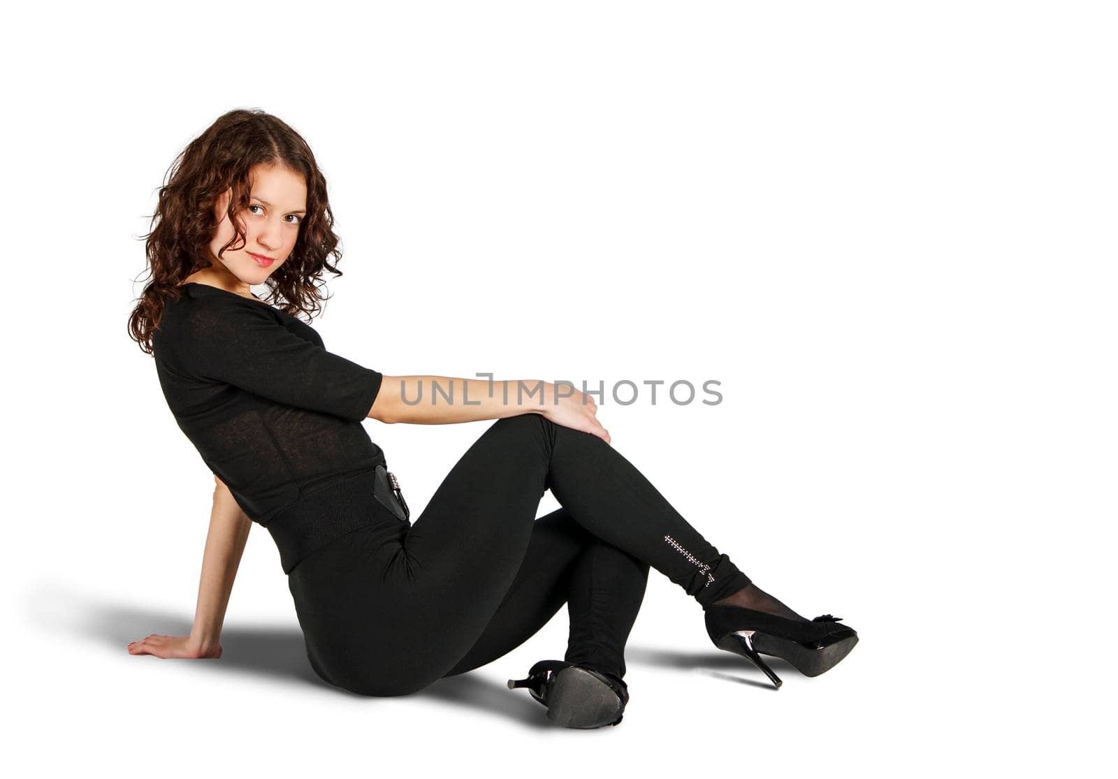 young beautiful woman in black suit posing sitting on the floor by raddnatt