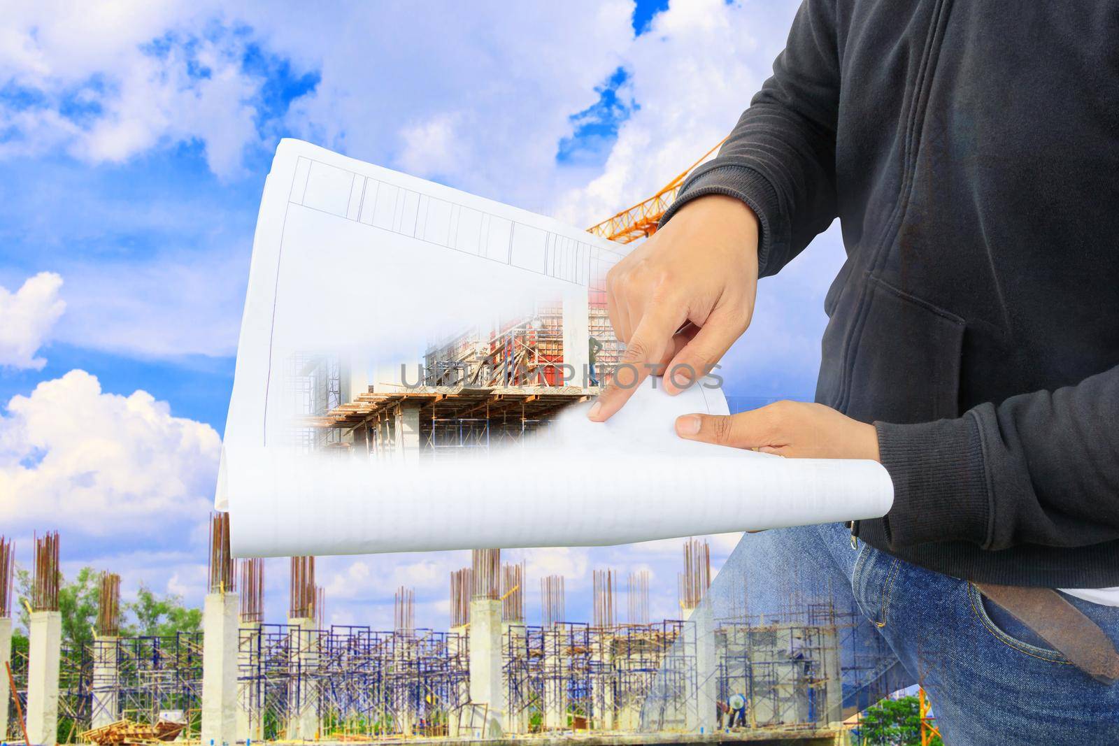 engineer finger point on paper plan blueprint in check building technician place construction site with copy space add text. concept Double Exposure by pramot