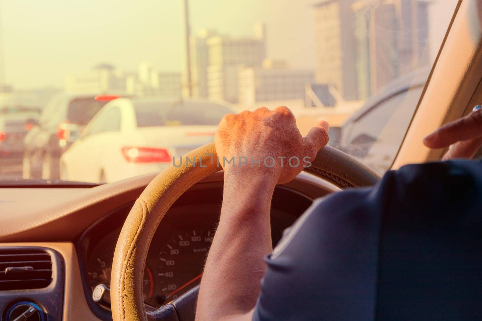 hand of man driving car travel on road Traffic jam and sunlight by pramot