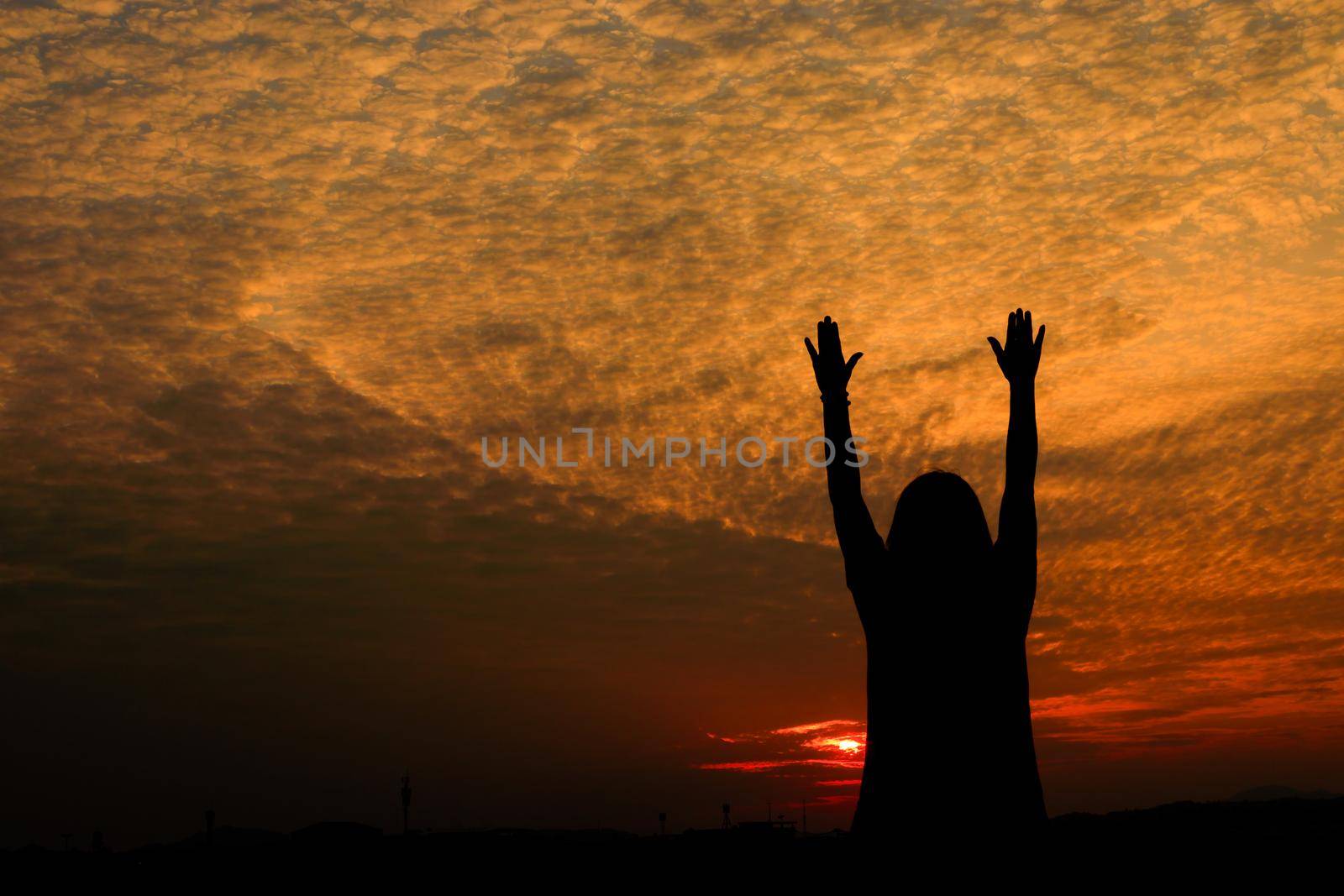 Silhouette of woman exercises riverside at sunset Yellow on sky beautiful in summer