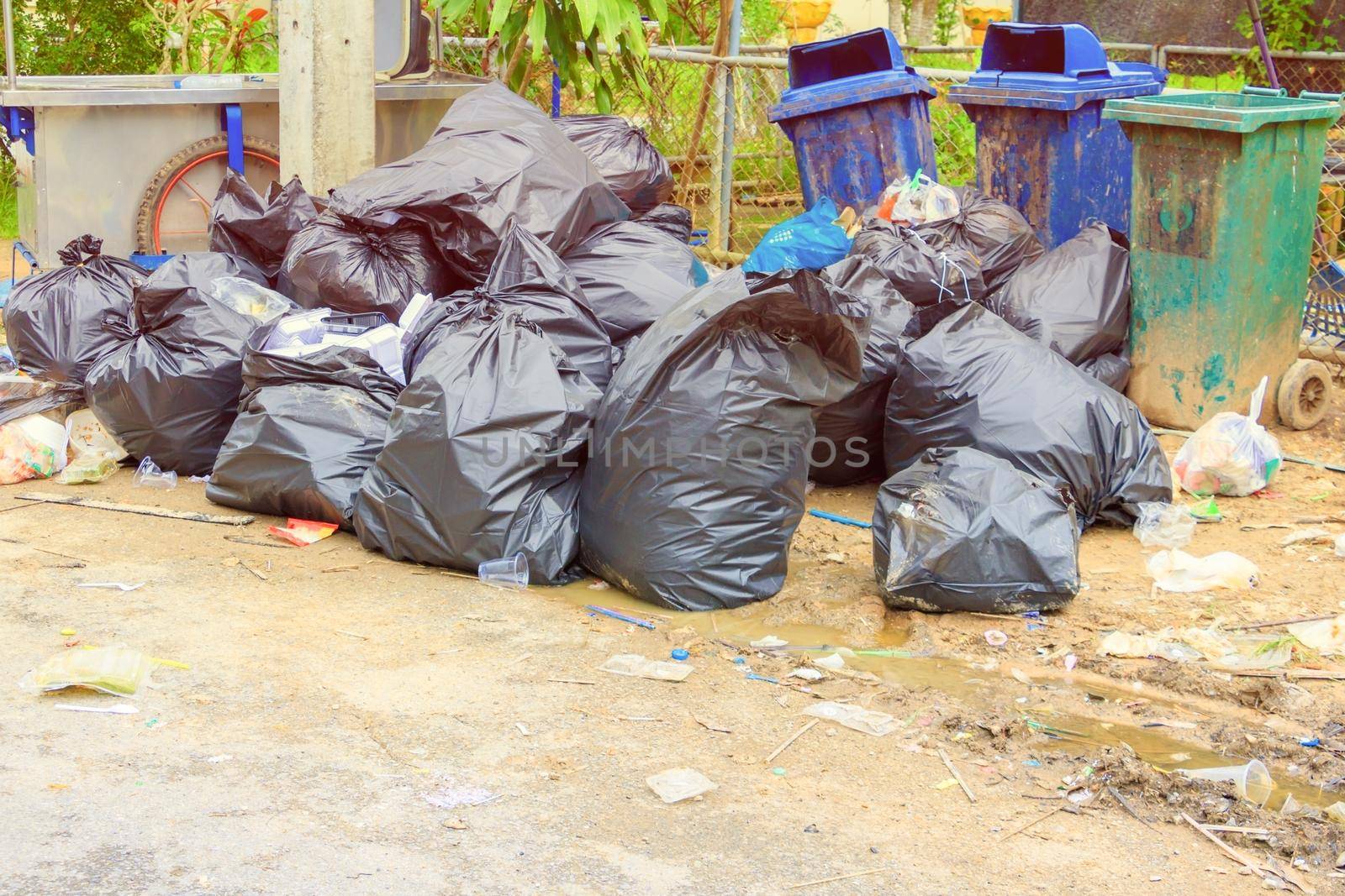 Pile garbage black bag plastic roadside in the city