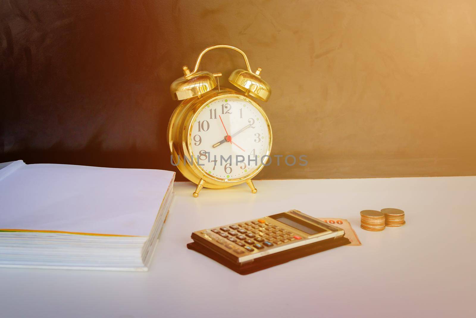 alarm clock old vintage gold, money and calculator over white and black background. with copy space add text retro style by pramot