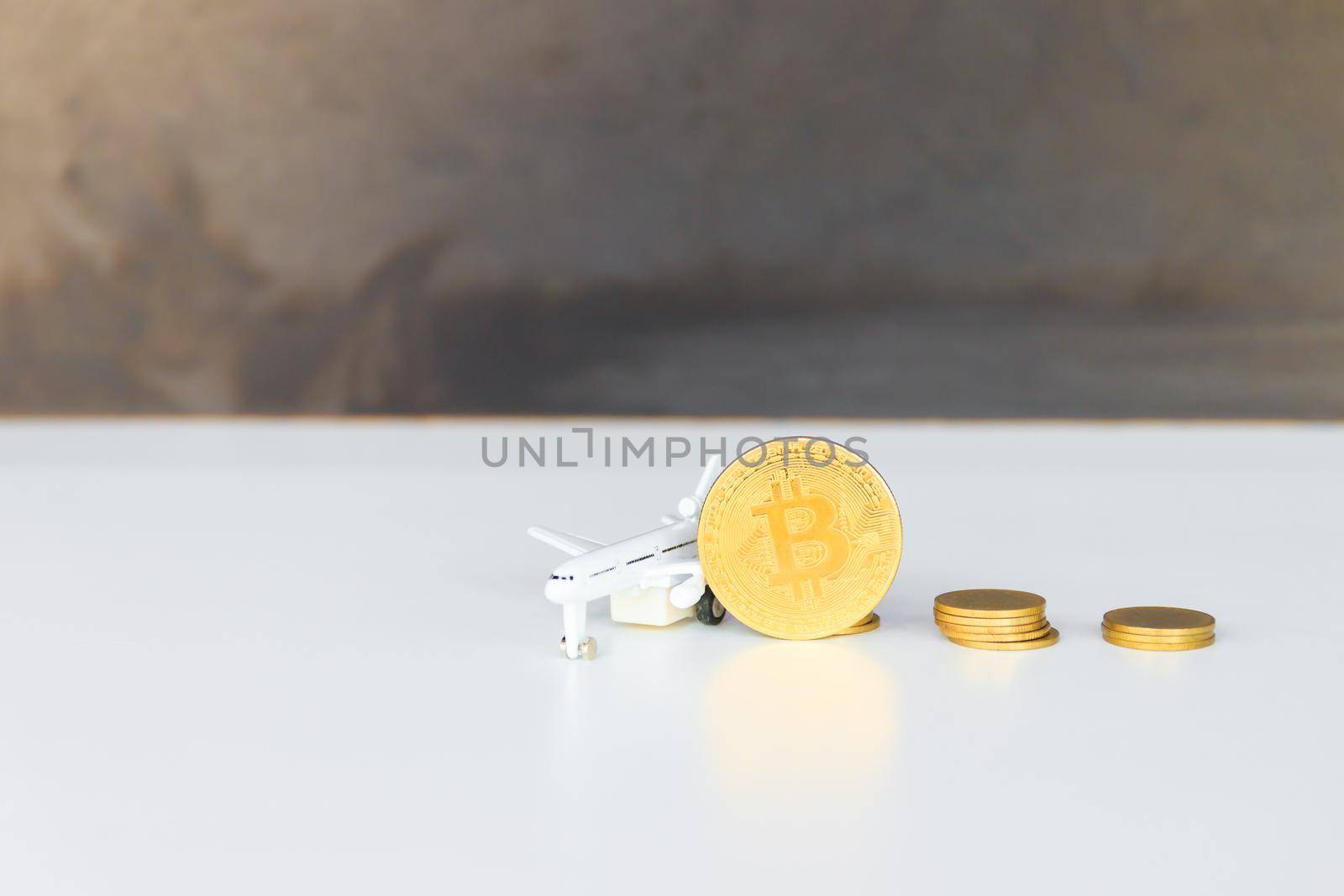 bitcoin coins and money stack and model of passenger plane  over white on black background. with copy space add text by pramot